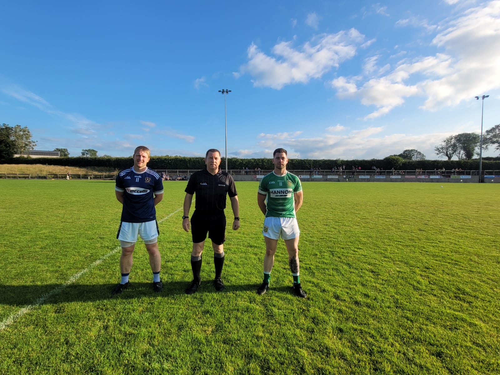 St Gall\'s captain Terry O\'Neill and Aghagallon skipper Gareth Magee pictured with referee Ray Matthews before Wednesday night\'s game at Páirc Na nGael 