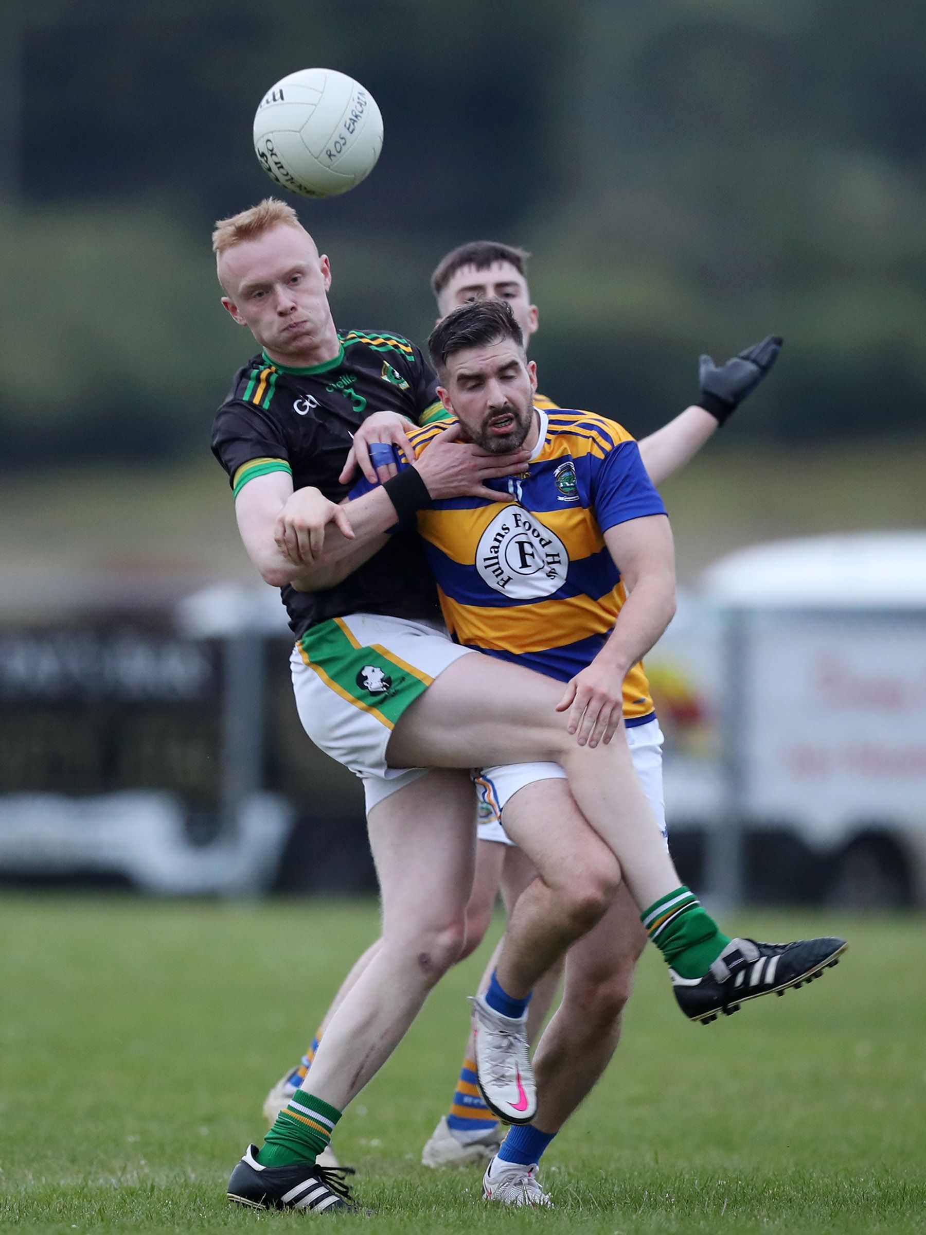 Pearse\'s full-back Thomas McFarlane and Rasharkin centre-forward Seamus Ellis fight for possession during Wednesday night\'s Division Three football final in Ahoghill 