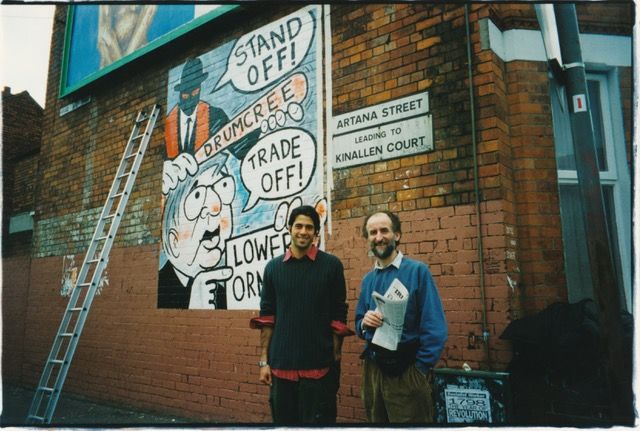WRITING ON THE WALL: Troy Garity and cartoonist Ian Knox at the famous mural in 1998