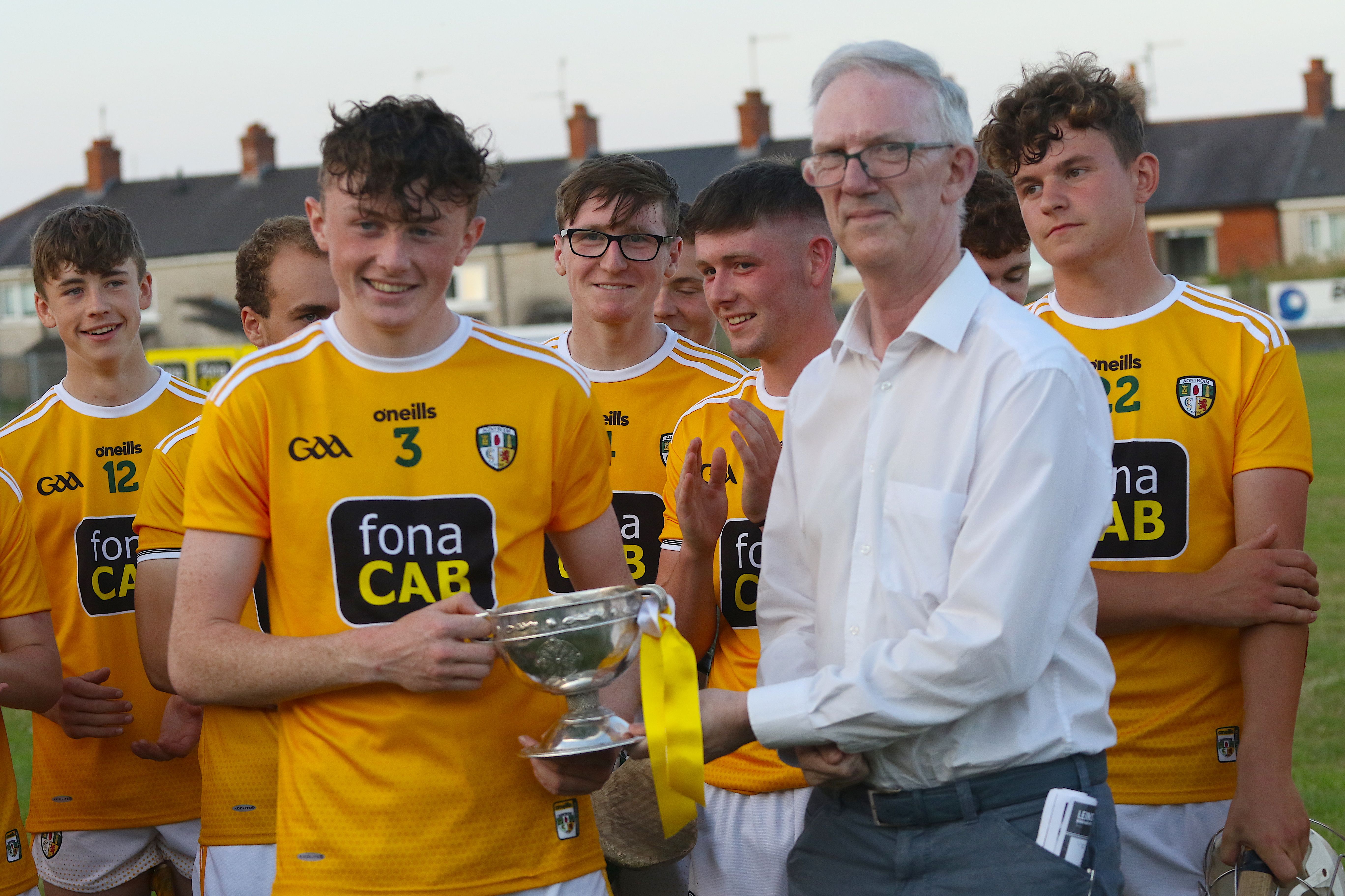Antrim captain, Ruairi McCormick, is presented with the trophy