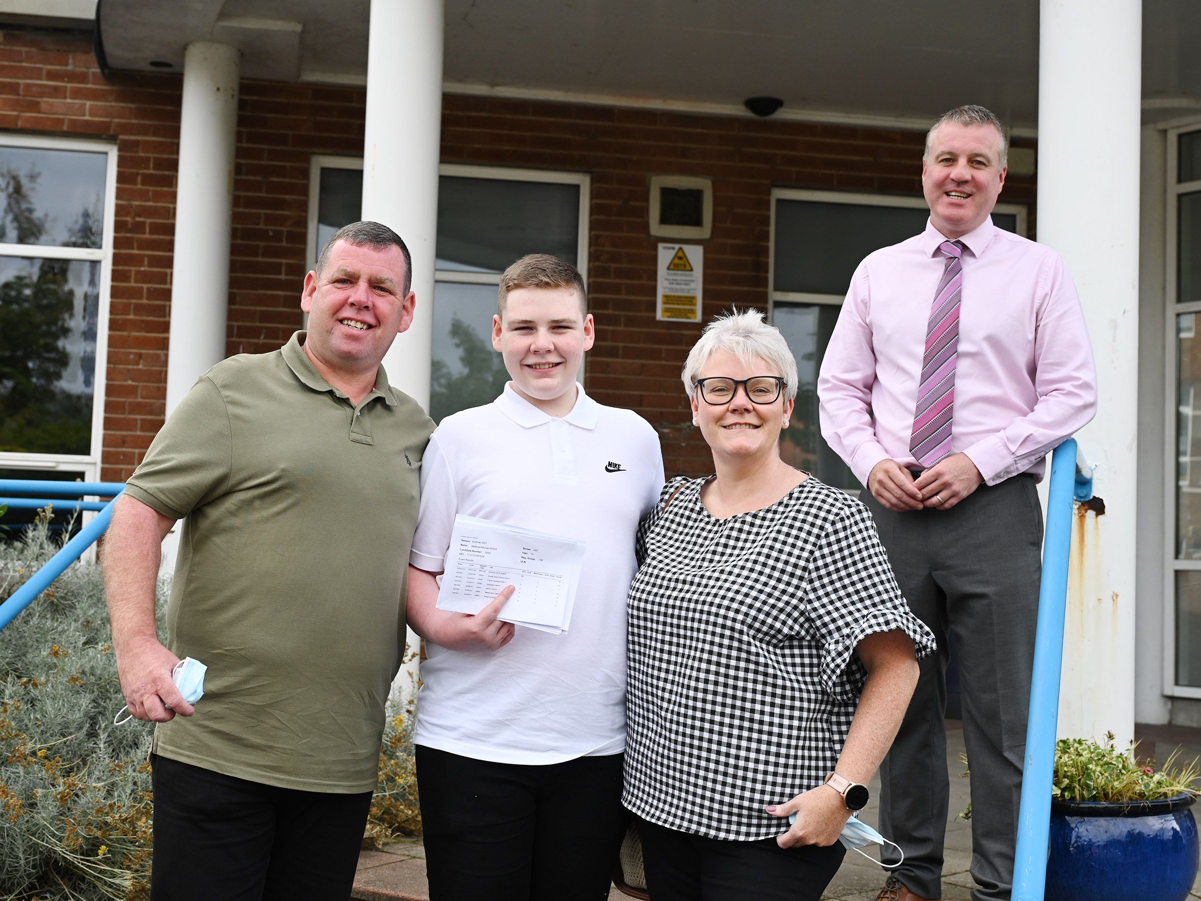 PROUD PARENTS: Michael and Paula Rocks with their son Matthew and All Saints College Vice-Principal, Damien Coyle