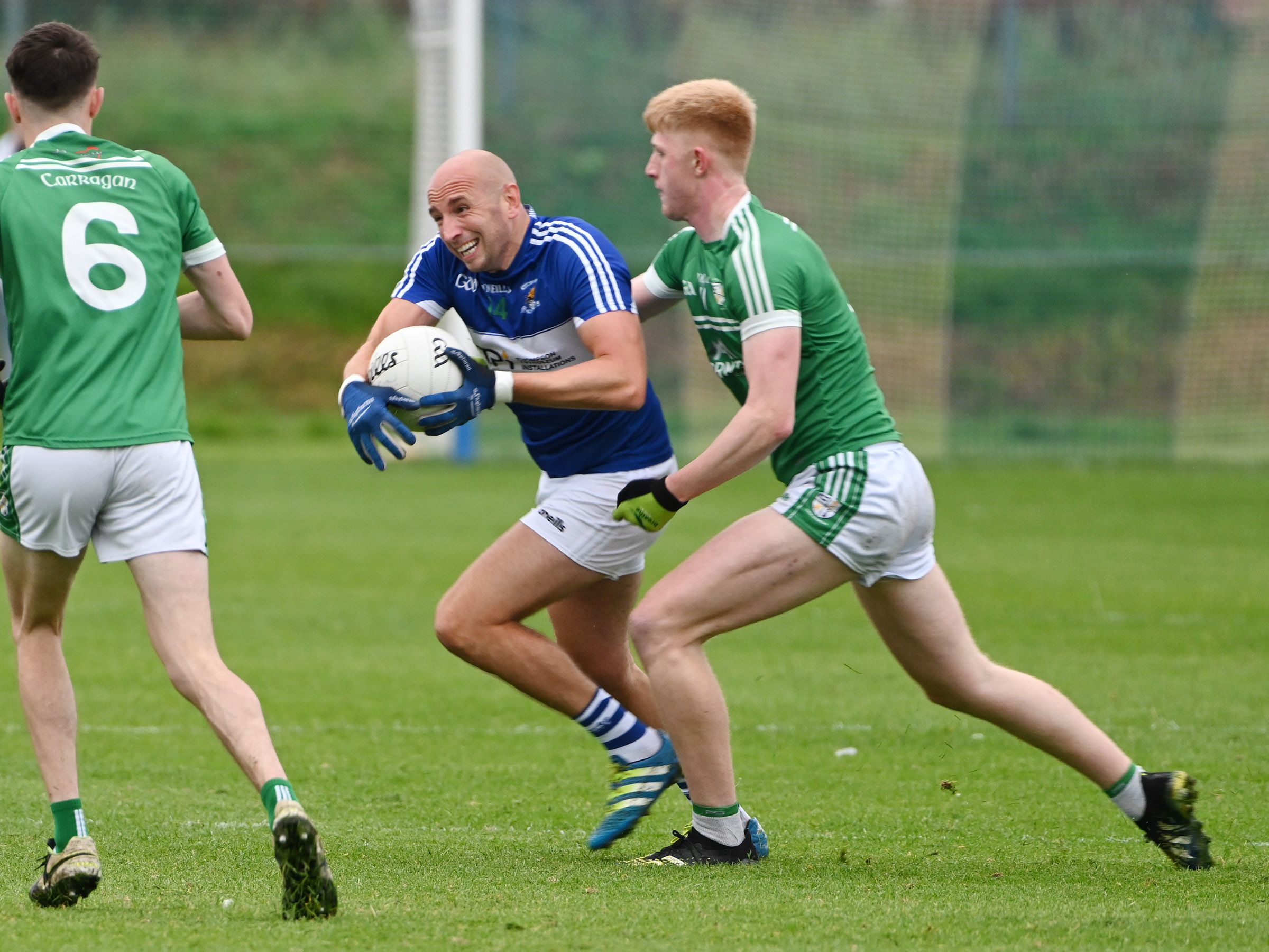 St John\'s full-forward Conal Kelly comes under pressure from Cargin\'s Pat Shivers during Friday night\'s Antrim SFC clash at Corrigan Park 