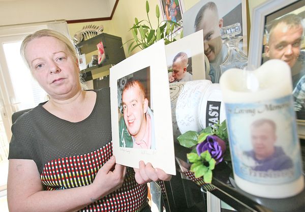 RELIEF: Patricia Brown surrounded by treasured portraits of her son Christopher Lavery, who died in 2017