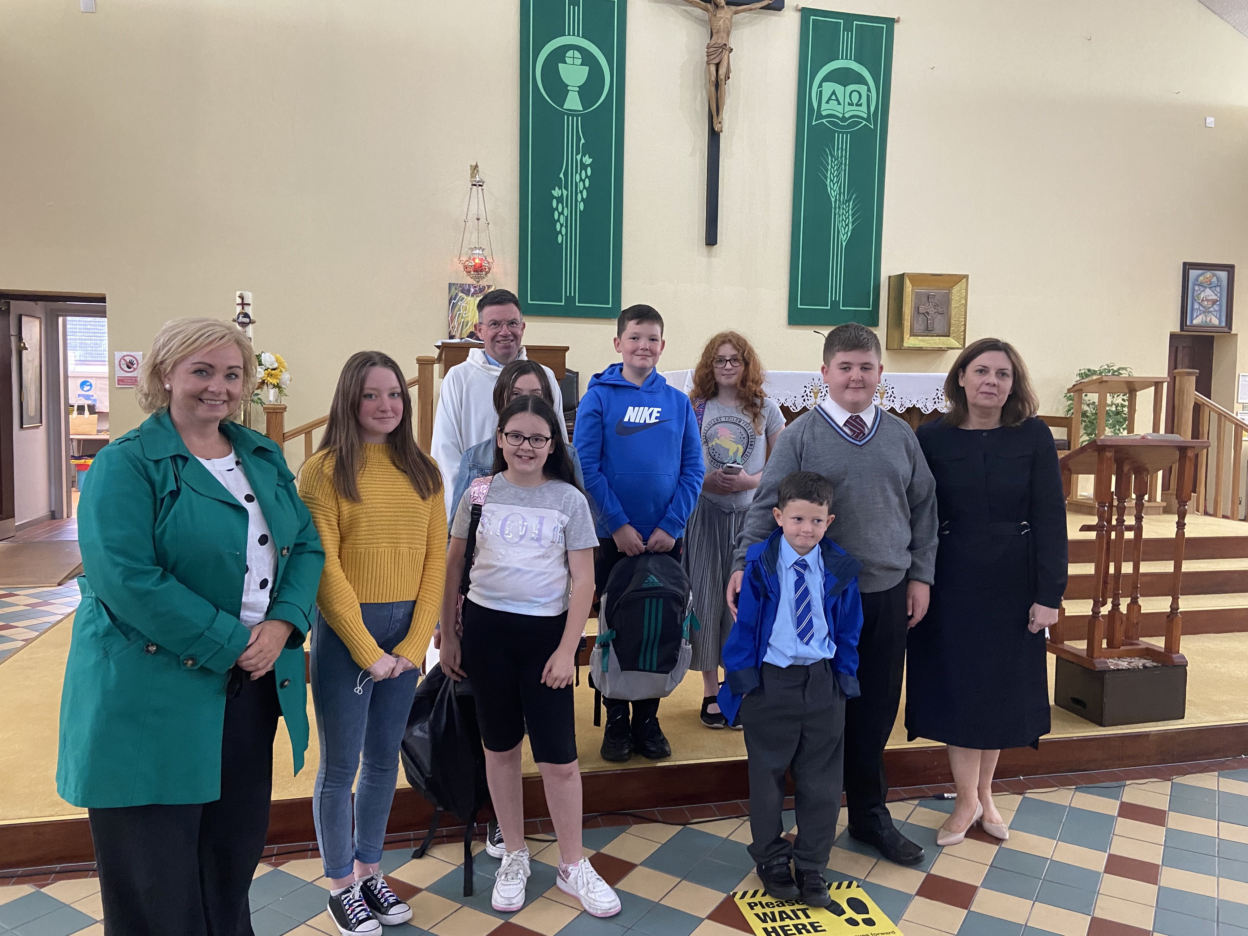 STEPPING UP: The parish community at St John\'s celebrating the transition to \'big school\'