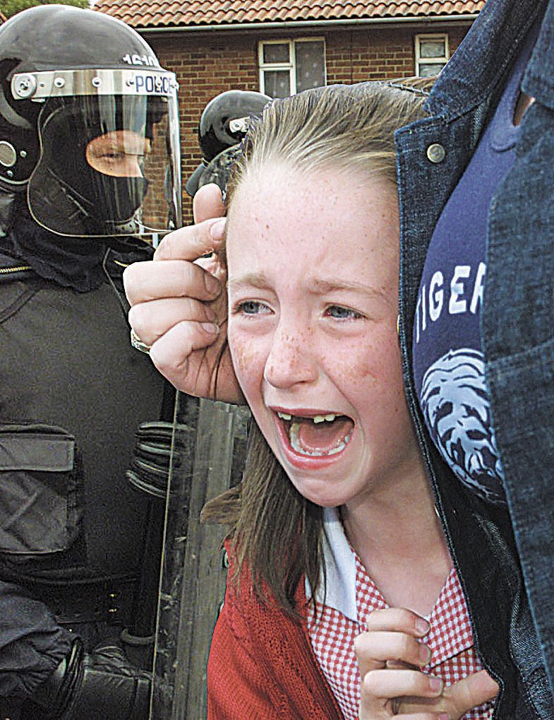 TRAUMATIC: Eirinn Flood on her way to school during the Holy Cross dispute in 2001.