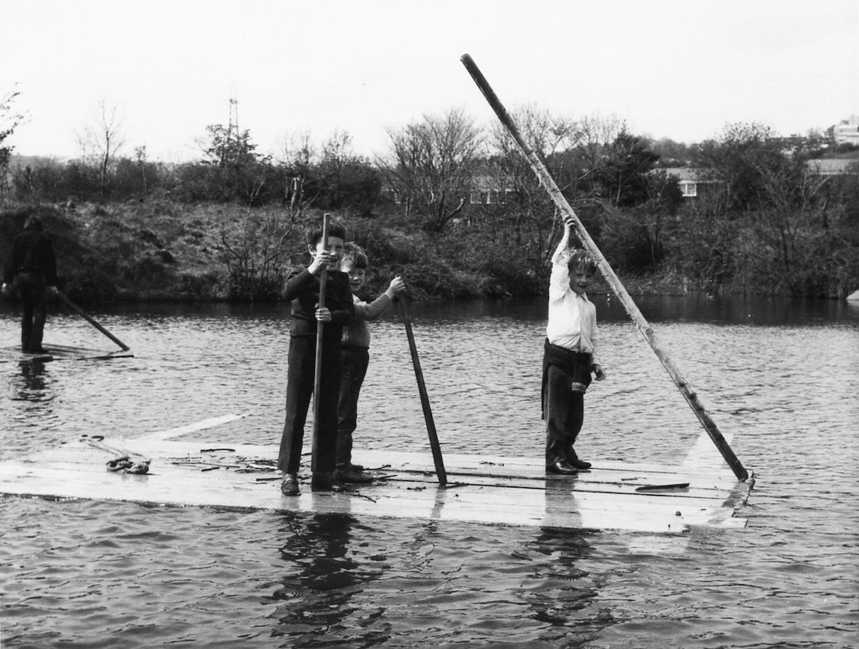 PADDLING: Local children enjoy some make shift rafts on the Half Moon Lake in 1971