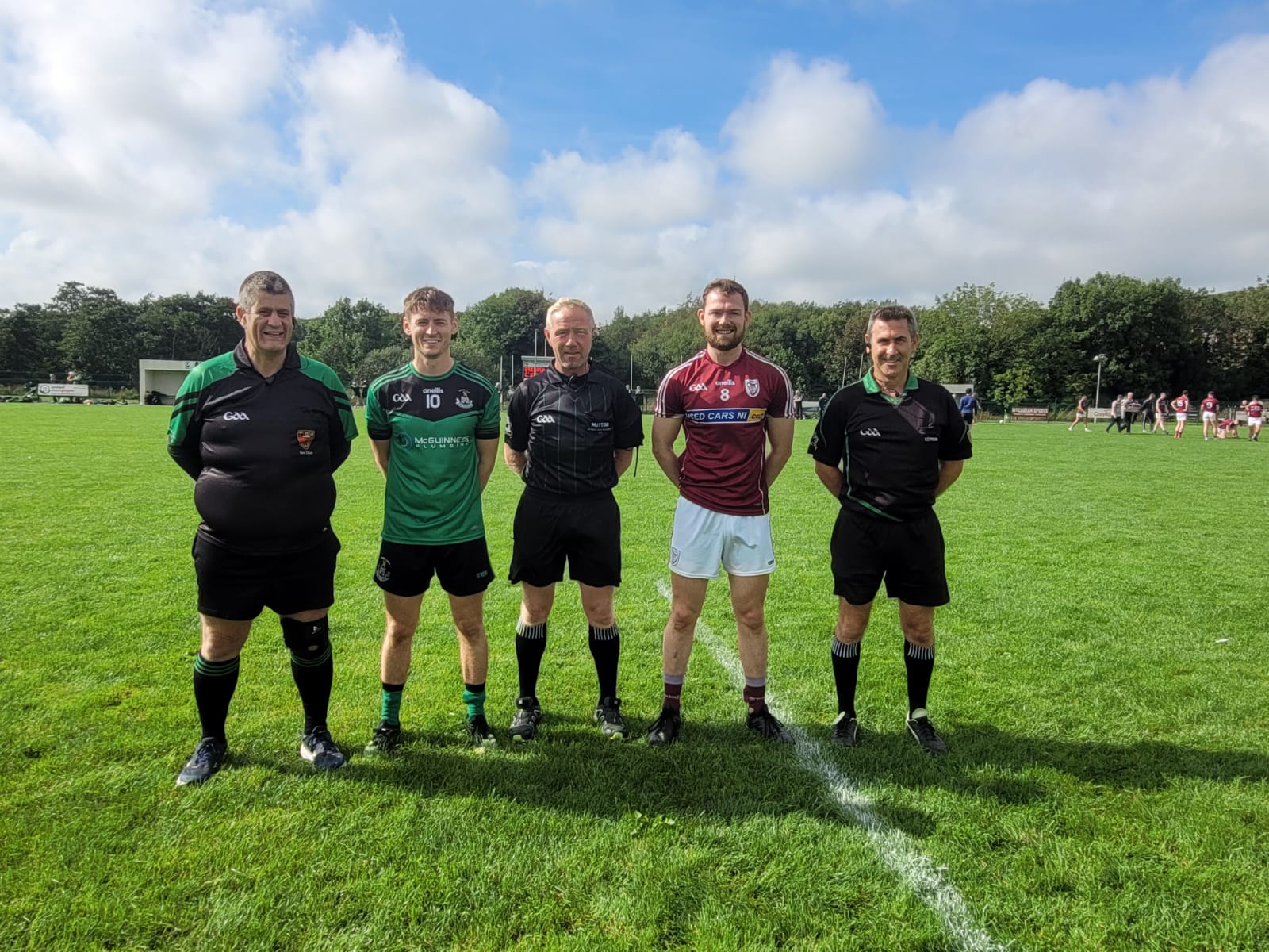 Team captains Cathal Crilly (Castlewellan) and John McKenna (Bredagh) pictured with referee Ciara Brannigan and his match officials before Saturday\'s Down SFC first round tie at Downpatrick RGU 