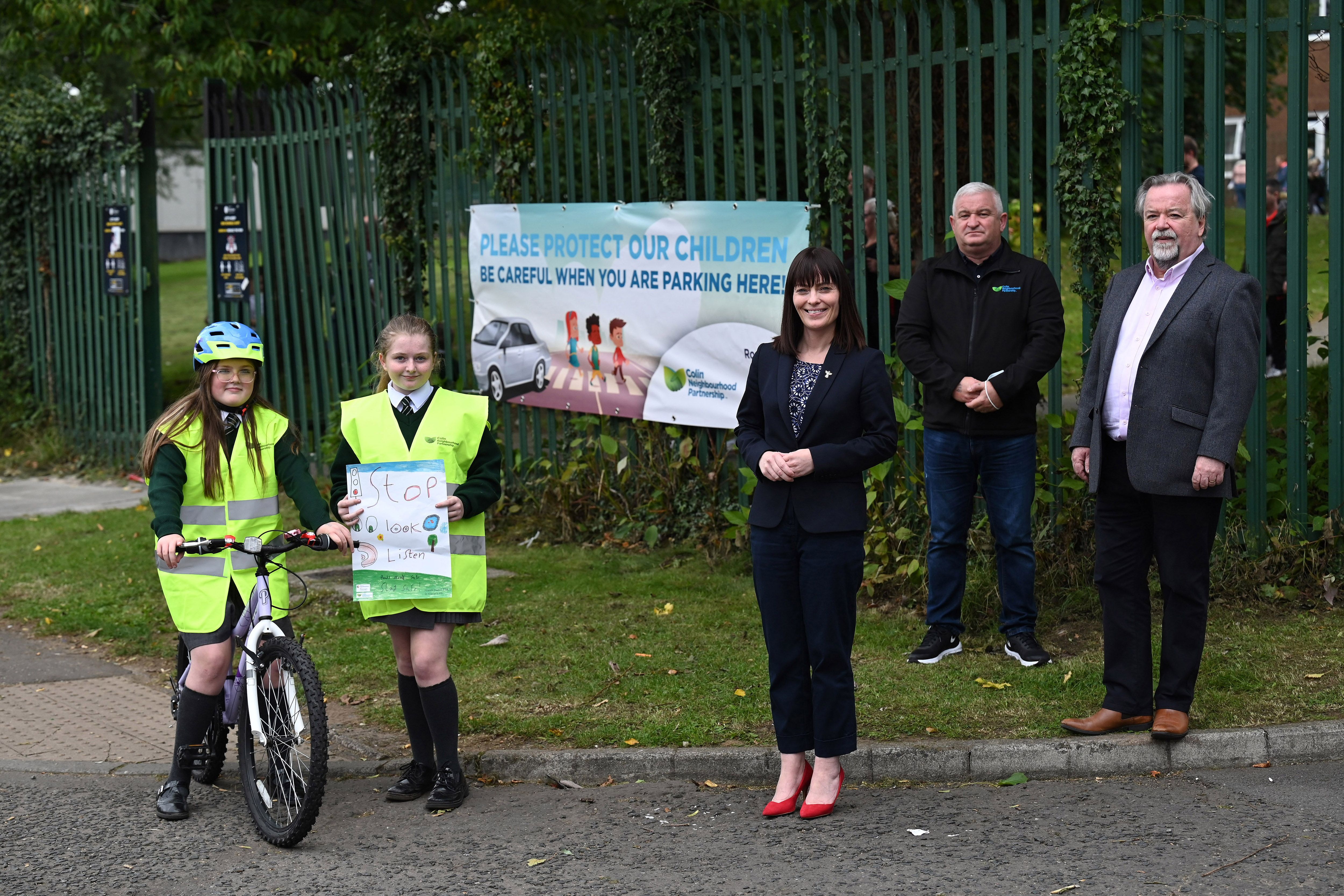 ROAD SAFETY: Minister Mallon is joined by Seamus McAleavey, Chief Executive of NICVA; Brendan McAteer, Colin Neighbourhood Partnership, and pupils from St Kieran’s Primary School, Niamh Hamill and Taylor Dowds, to launch the scheme
