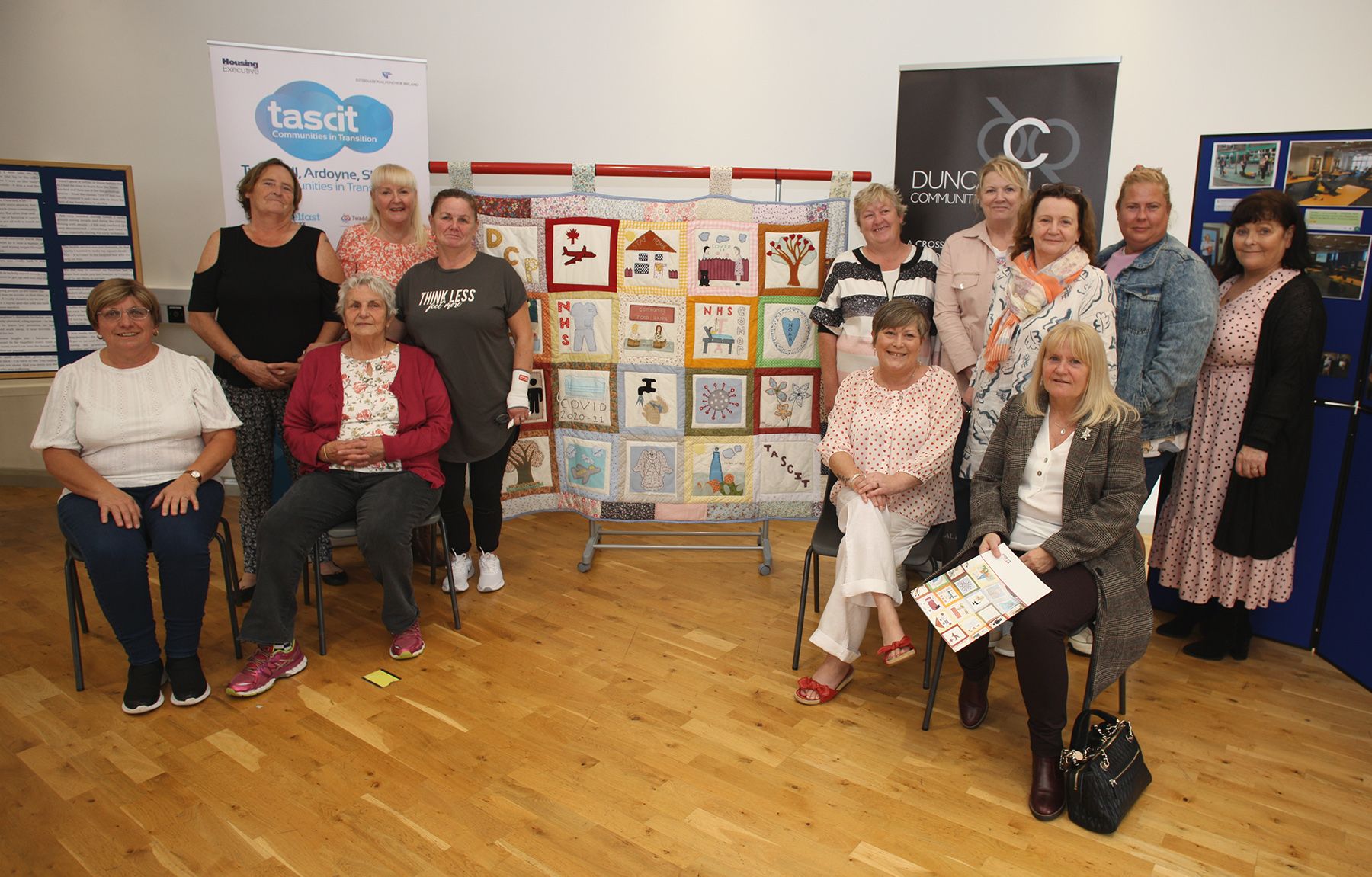 TEAMWORK: Residents from TASCIT and DCP with the Covid quilt 