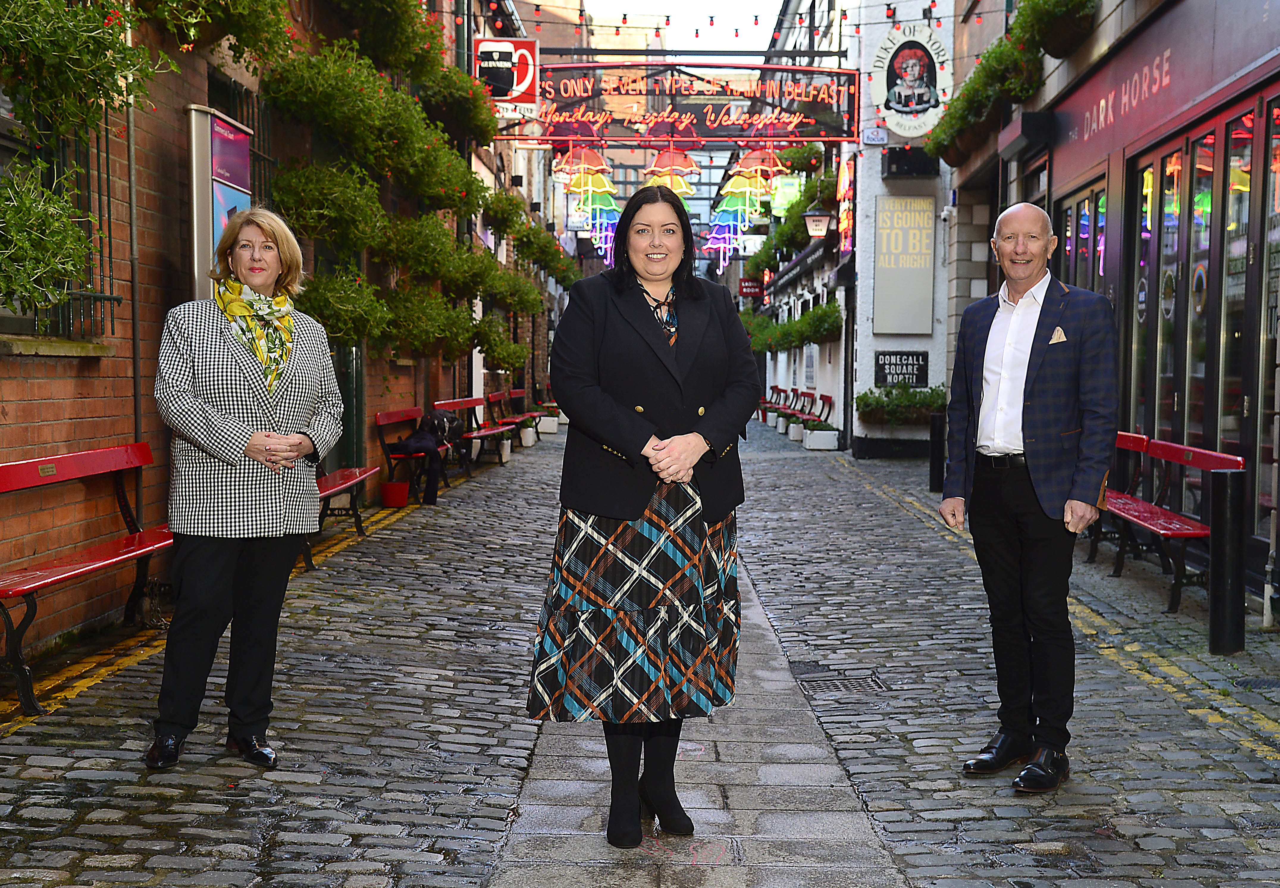 CHANGES: Minister Deirdre Hargey is joined by Colin Neill of Hospitality Ulster and Janice Gault of the NI Hotels Federation in the Cathedral Quarter of Belfast for the announcement