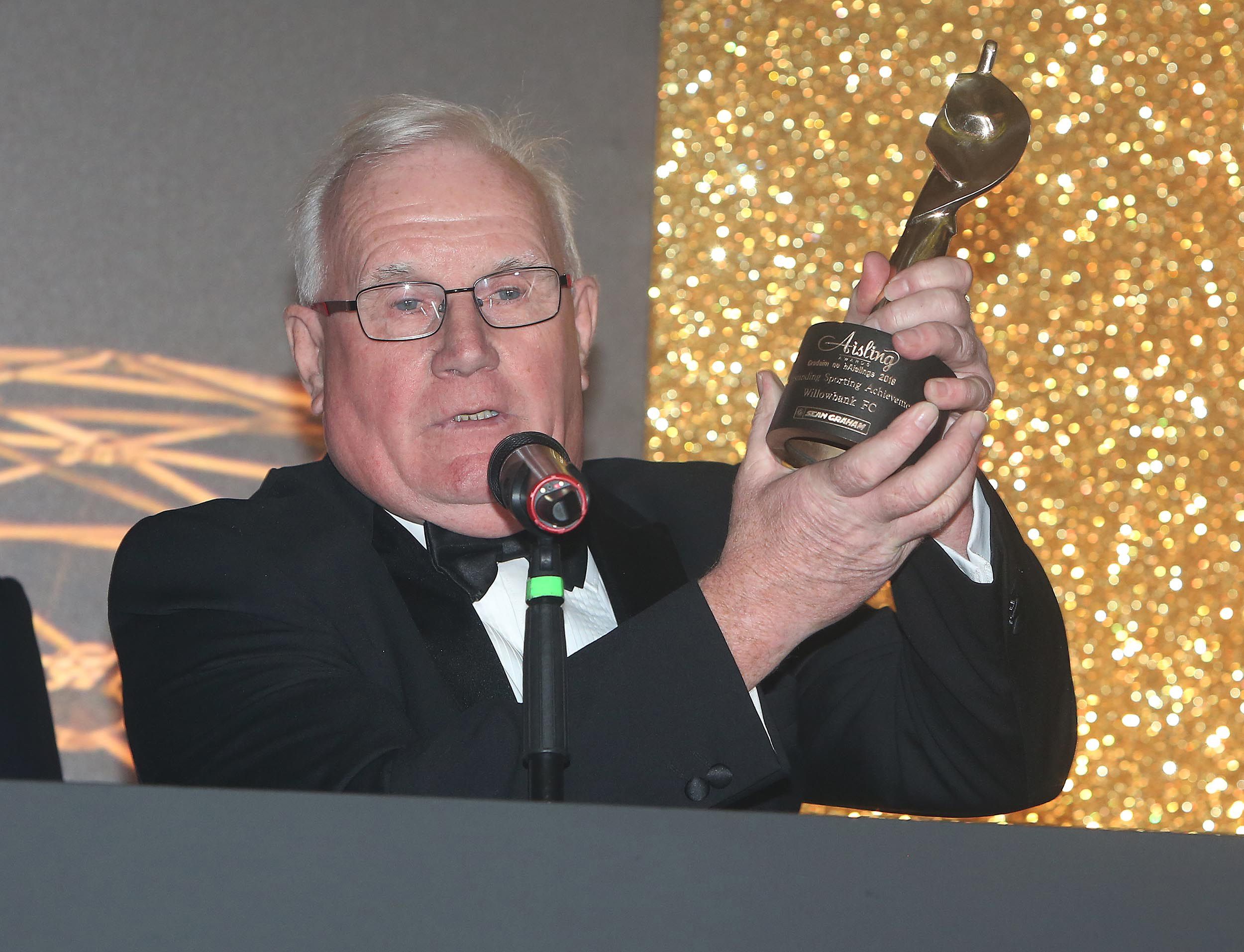 REMEMBERED:  Geordie with the Aisling Sports Award which was awarded to Willowbank FC in 2018