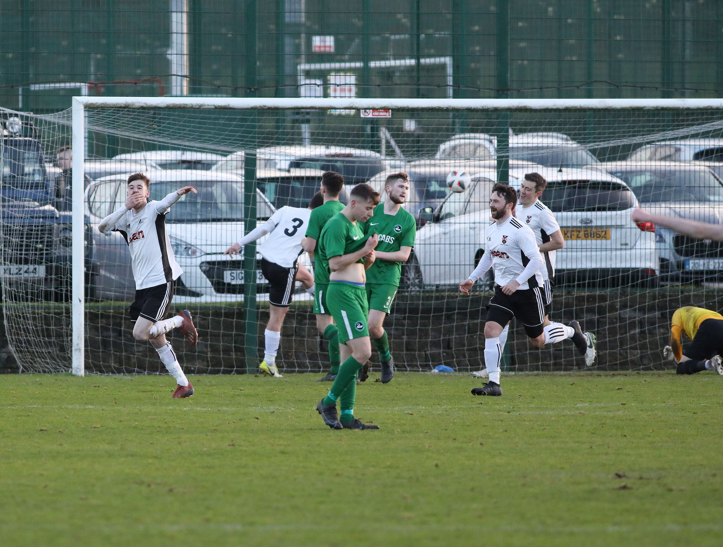 Caoimhin McGuinness celebrates as he seals victory for Queen\'s with the second goal