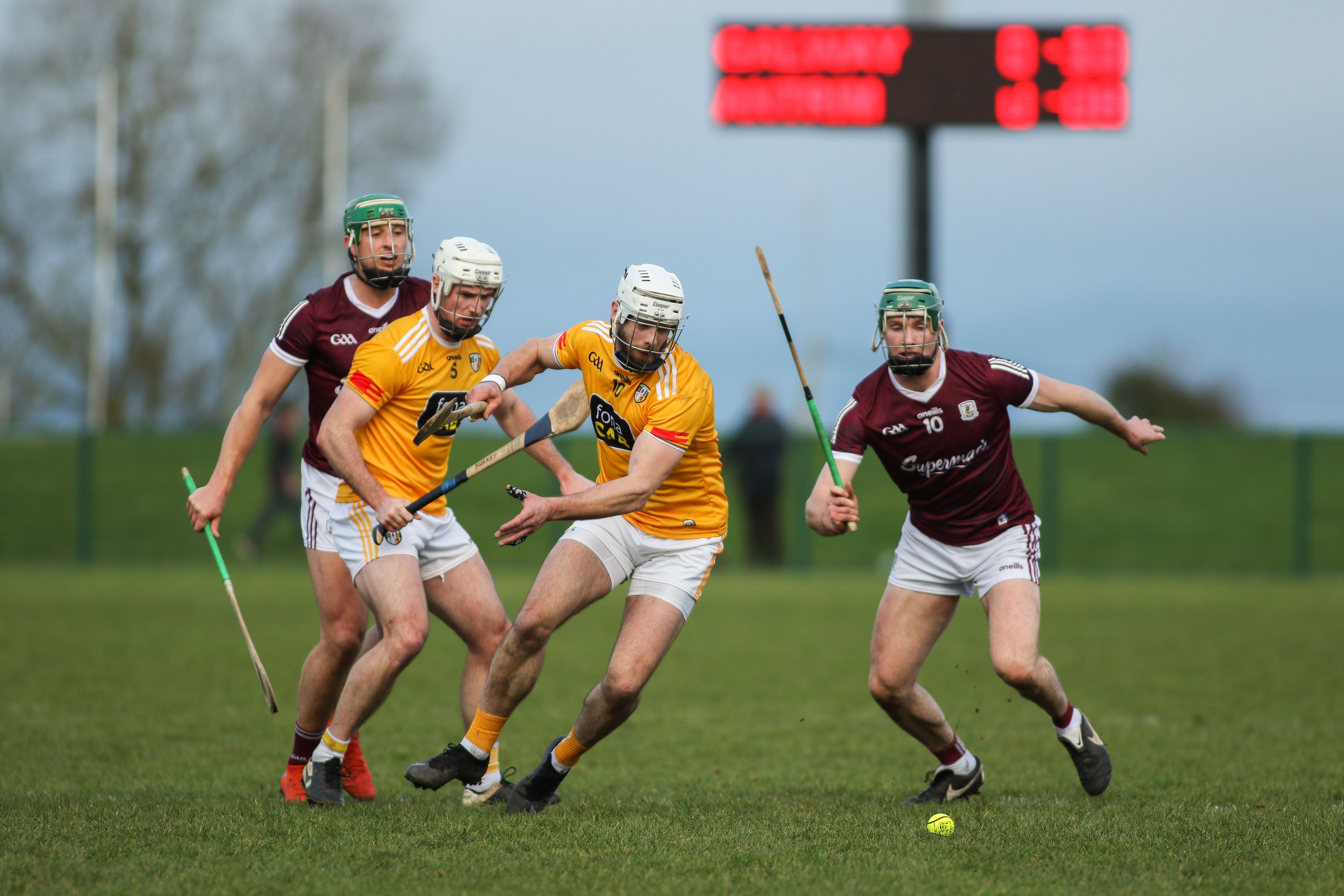 Neil McManus and Cathal Mannion battle for possession as Paddy Burke looks on