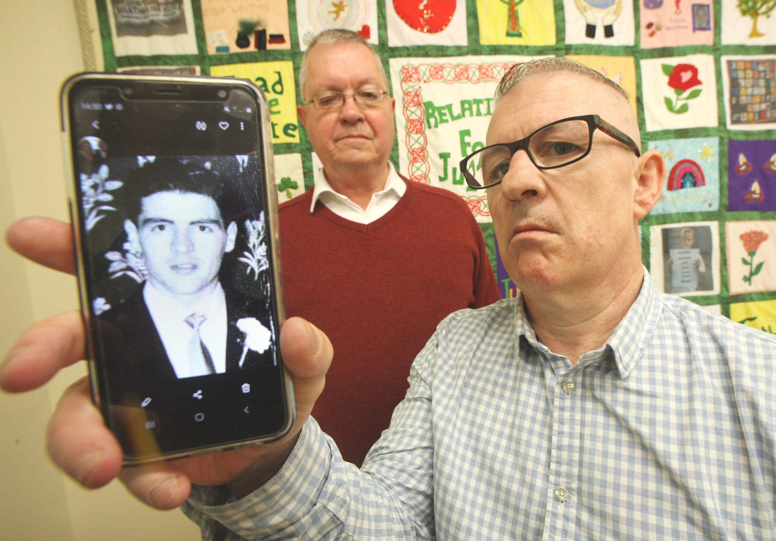 CASE: Stan Carberry with a photo of his father, also Stan, who was shot dead in 1972. Mike Ritchie (background) from RFJ has been working on the case with the Carberry family