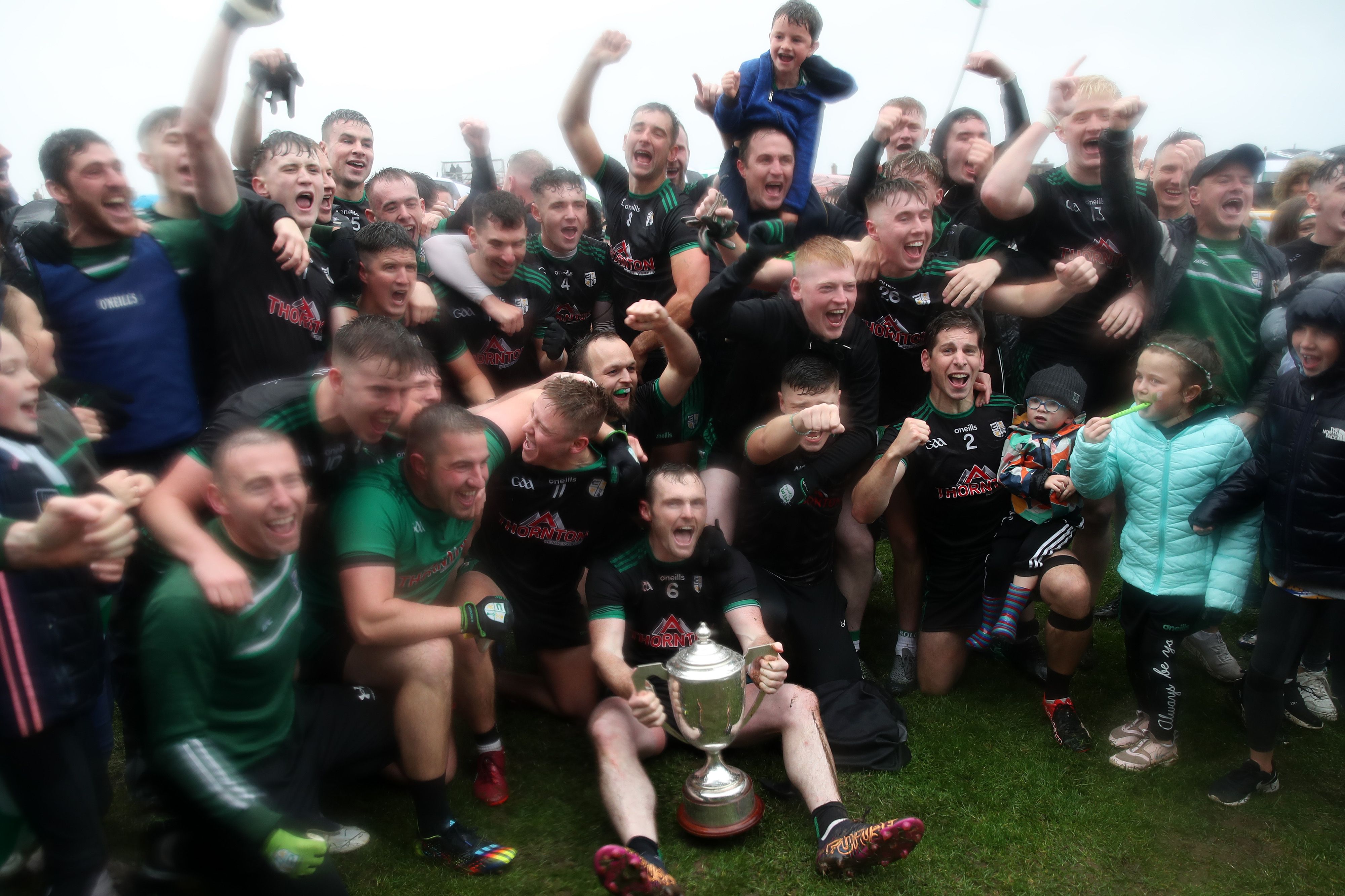 Cargin celebrate with the Padraig MacNamee Cup after their extra-time win over Aghagallon