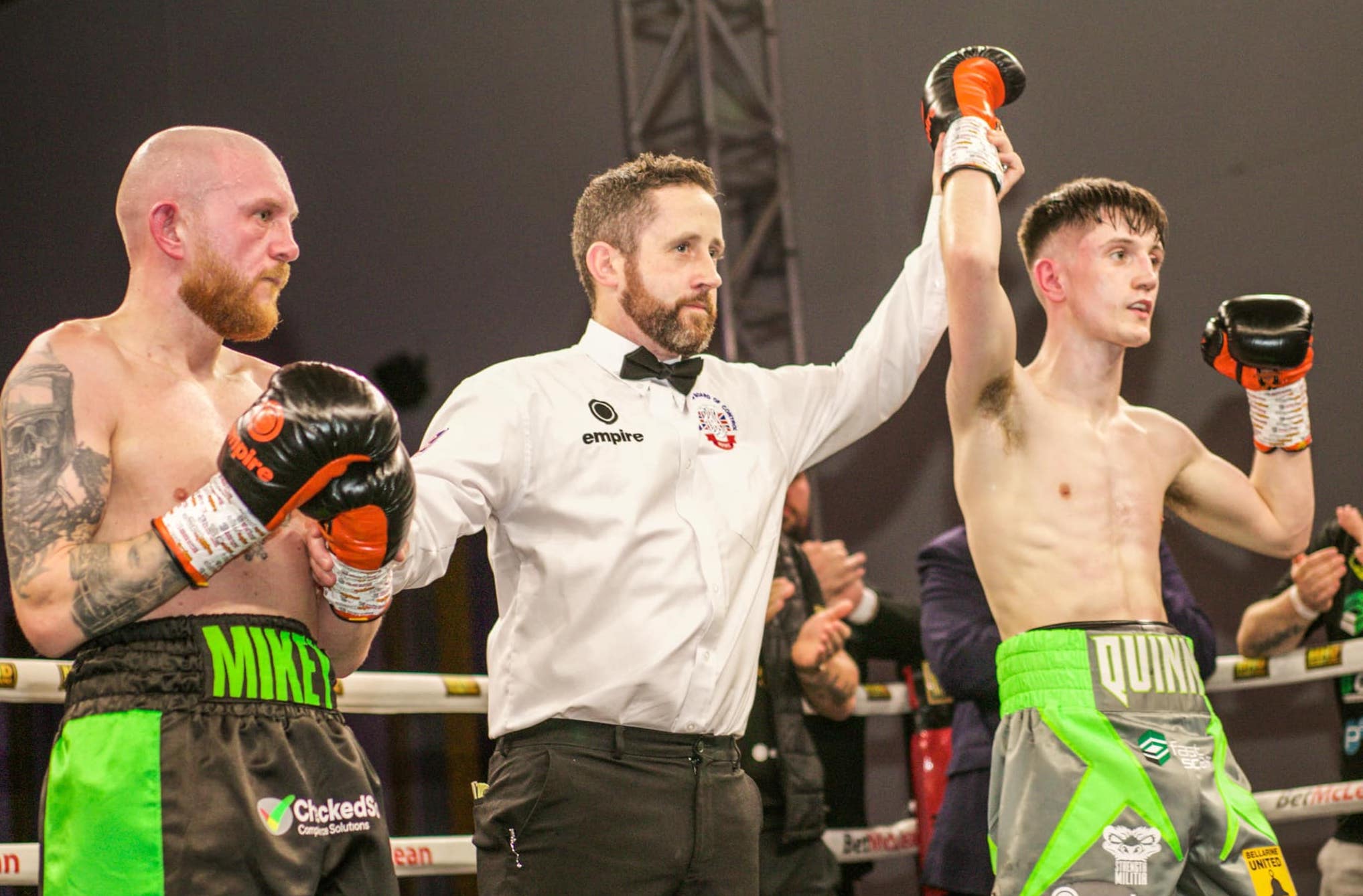 Conor Quinn has his hand raised in victory by referee Hugh Russell Jnr 