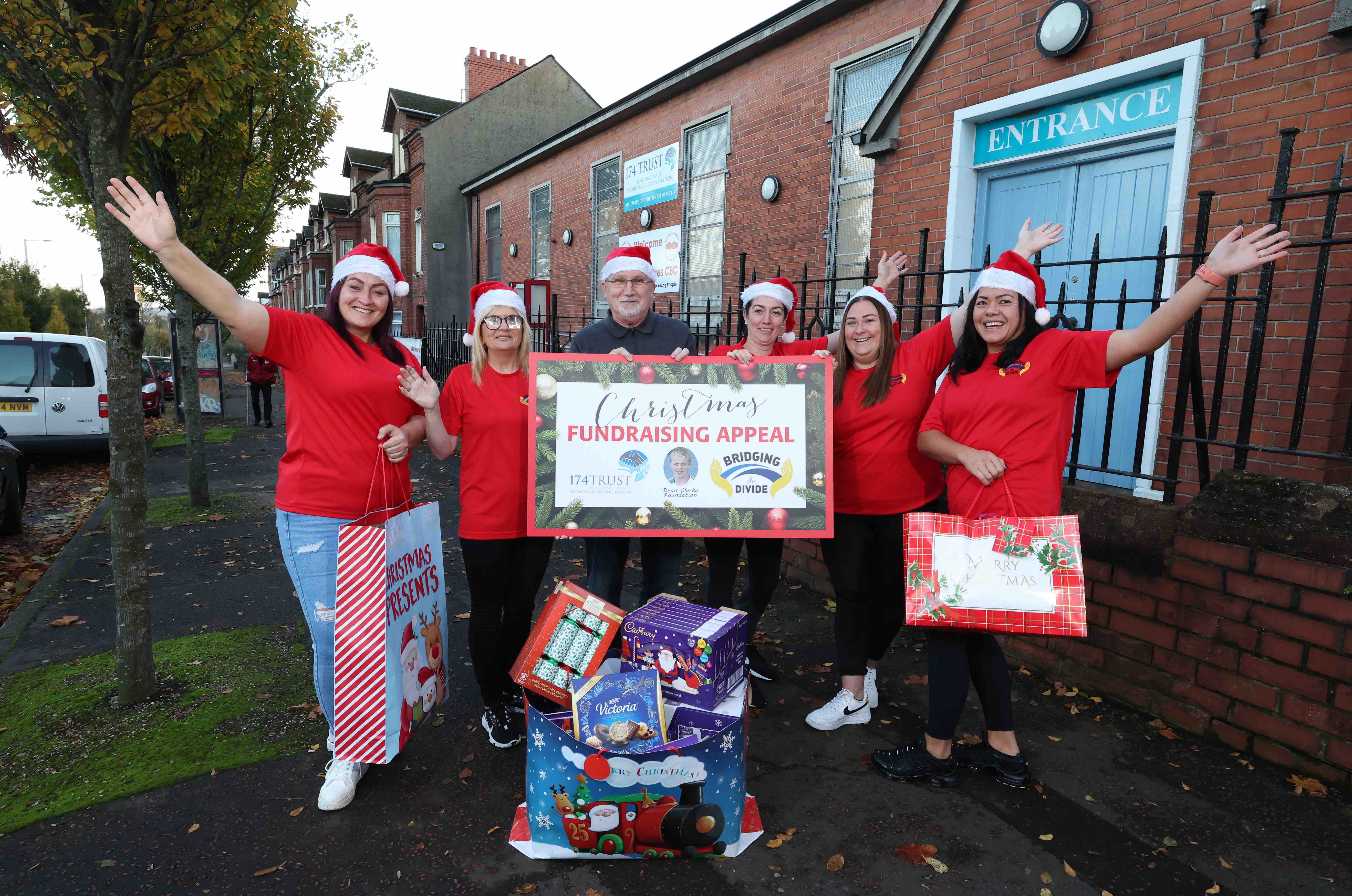 CHRISTMAS GIVING: Rosie Bradley from Bridging the Divide, Alison Clarke from The Dean Clarke Foundation and Bill Shaw from 174 Trust with members of the Bridging the Divide initiative