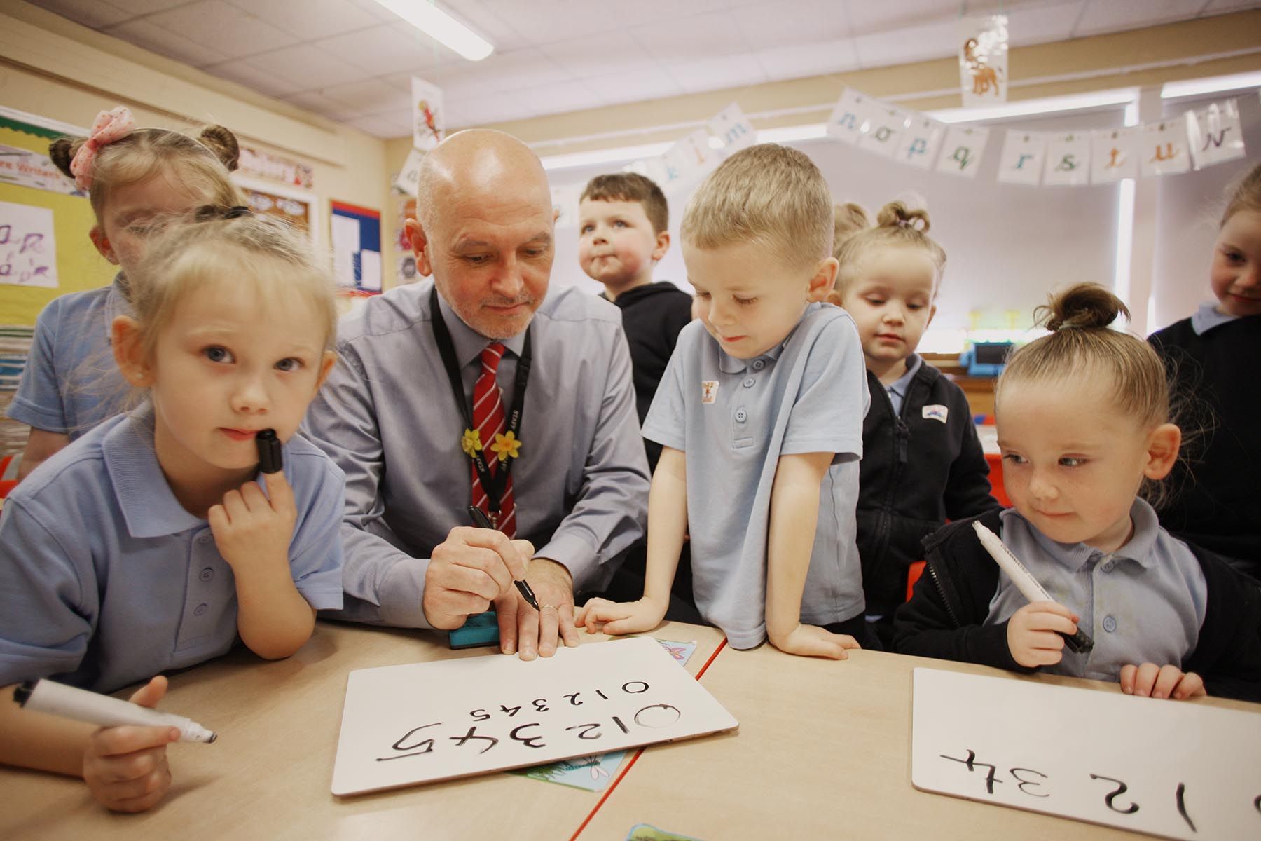 LEARNING: Principal Damian O’Neill with Primary 1 pupils