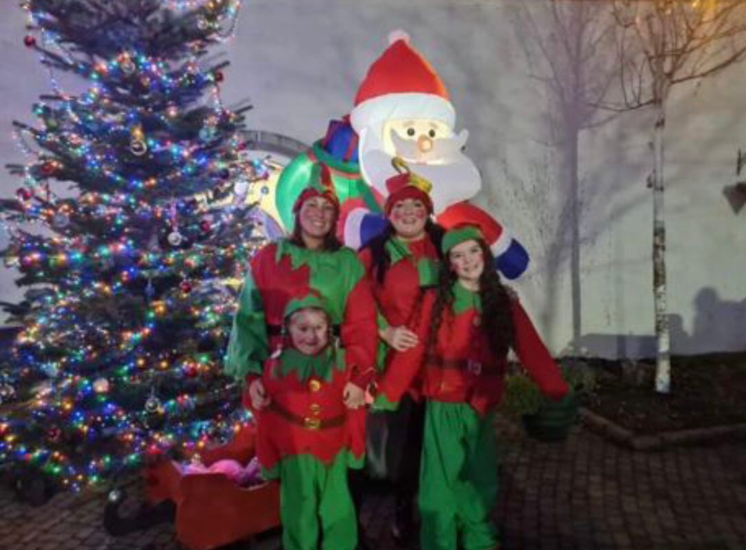 HO HO HO: Festive elves are ready to welcome everyone to the Christmas celebrations