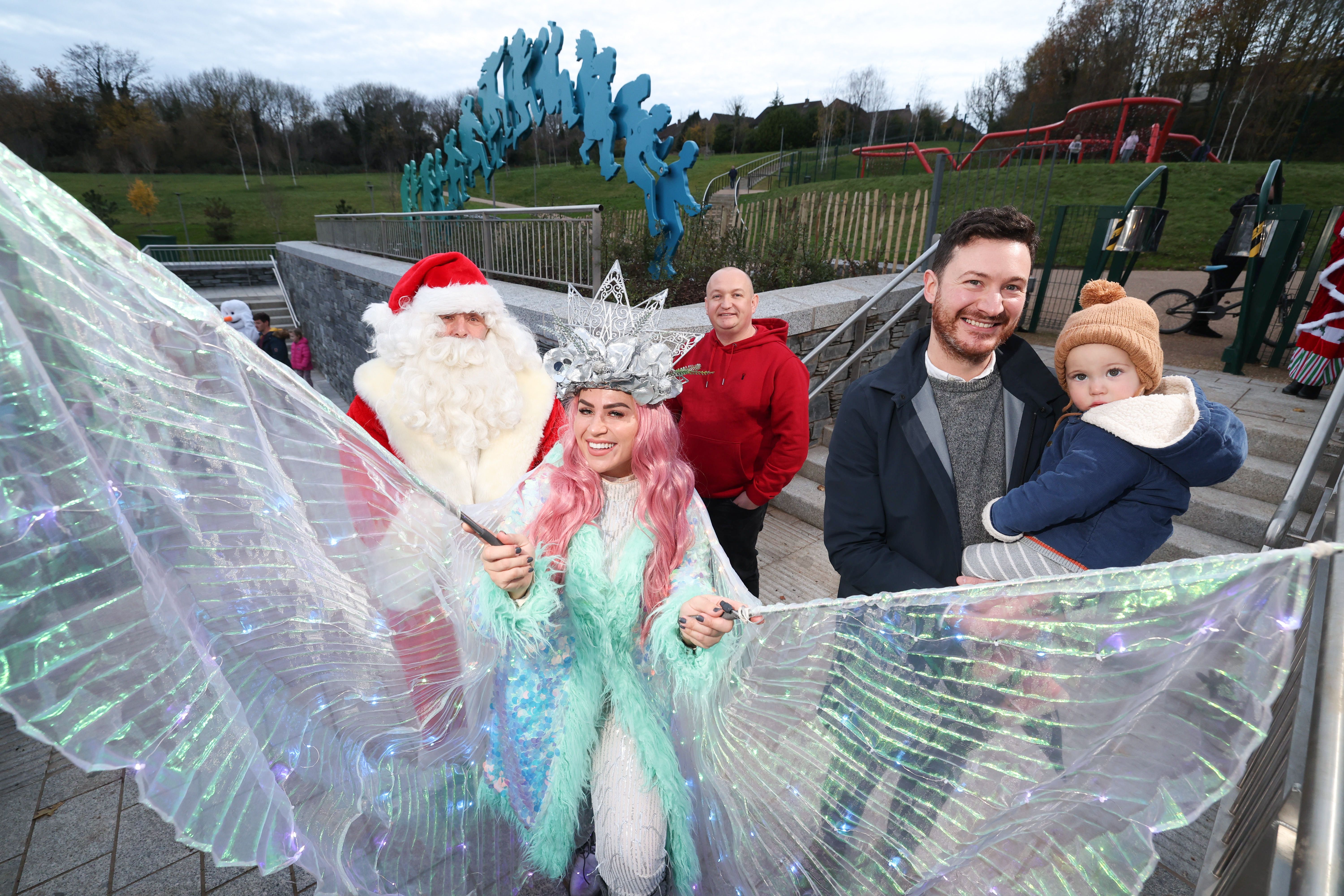 WINTER WONDERLAND: Councillor Ross McMullan and daughter Heidi with John Paul Russell (Colin Neighbourhood Partnership), Santa Claus and the Winter Fairy at Páirc Nua Chollann