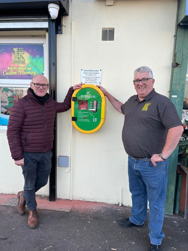 LIFE SAVING: Paul Maskey with Bumper Crawford from Kolormaster with the new defibrillator