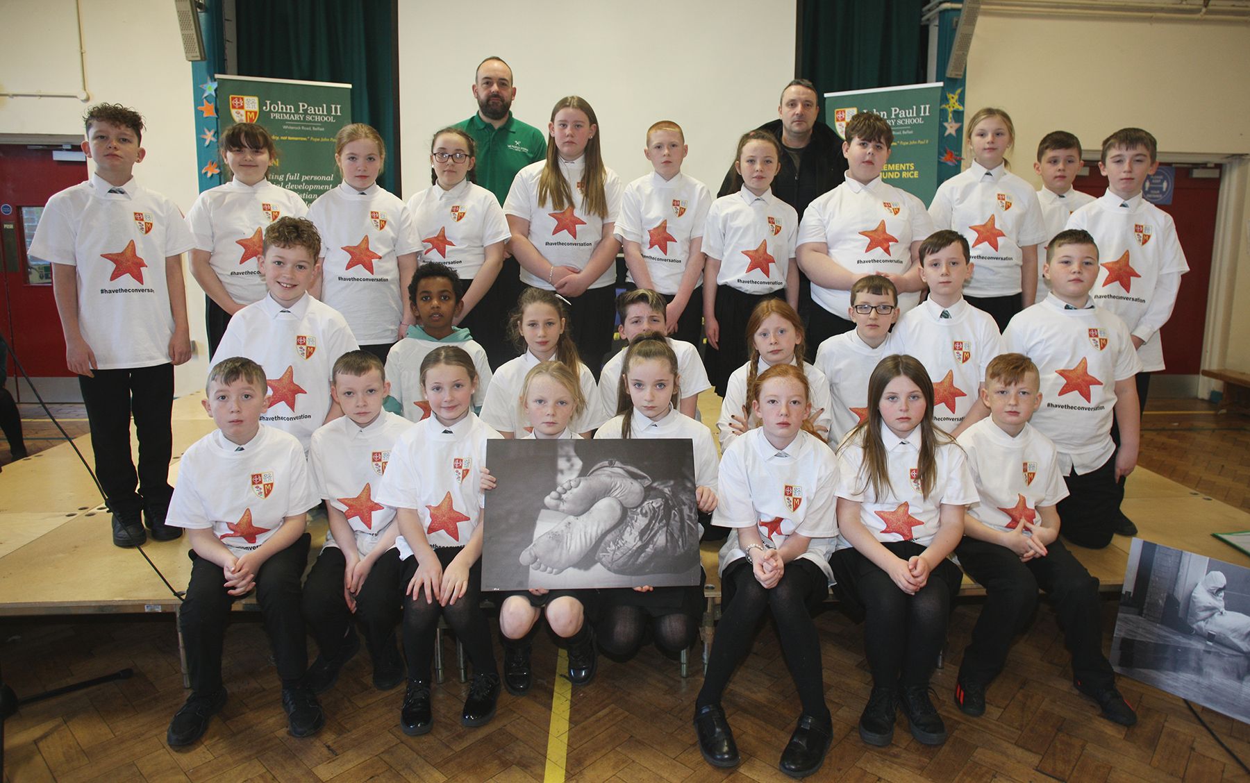 AWARENESS: John Paul II PS pupils with Paul McCusker from the People’s Kitchen and Cormac McArt from the Westcourt Centre. The t-shirts were supplied by Kolor Master