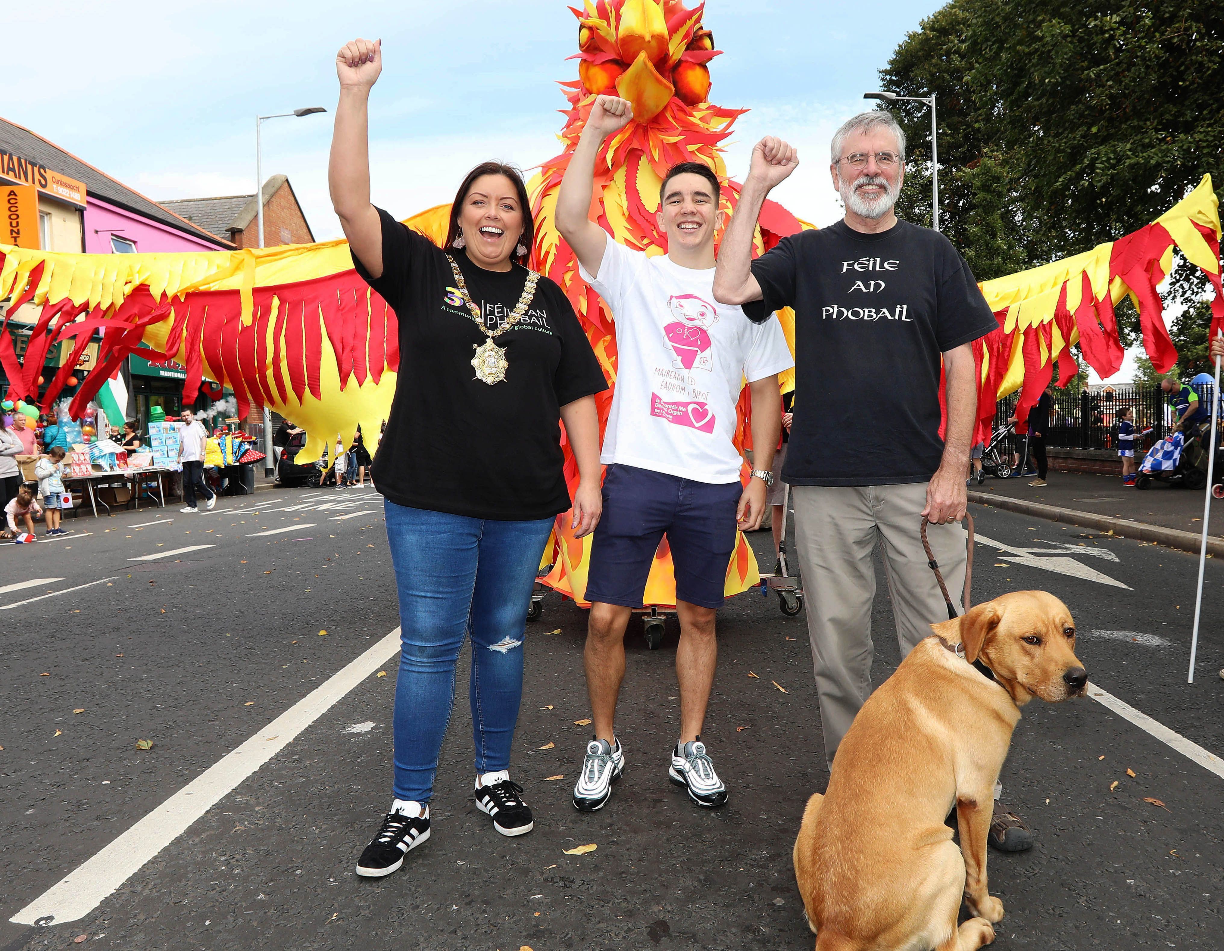 Gerry Adams on the Féile Carnival Parade in 2018 with then Lord Mayor Deirdre Hargey and champion boxer Michael Conlan