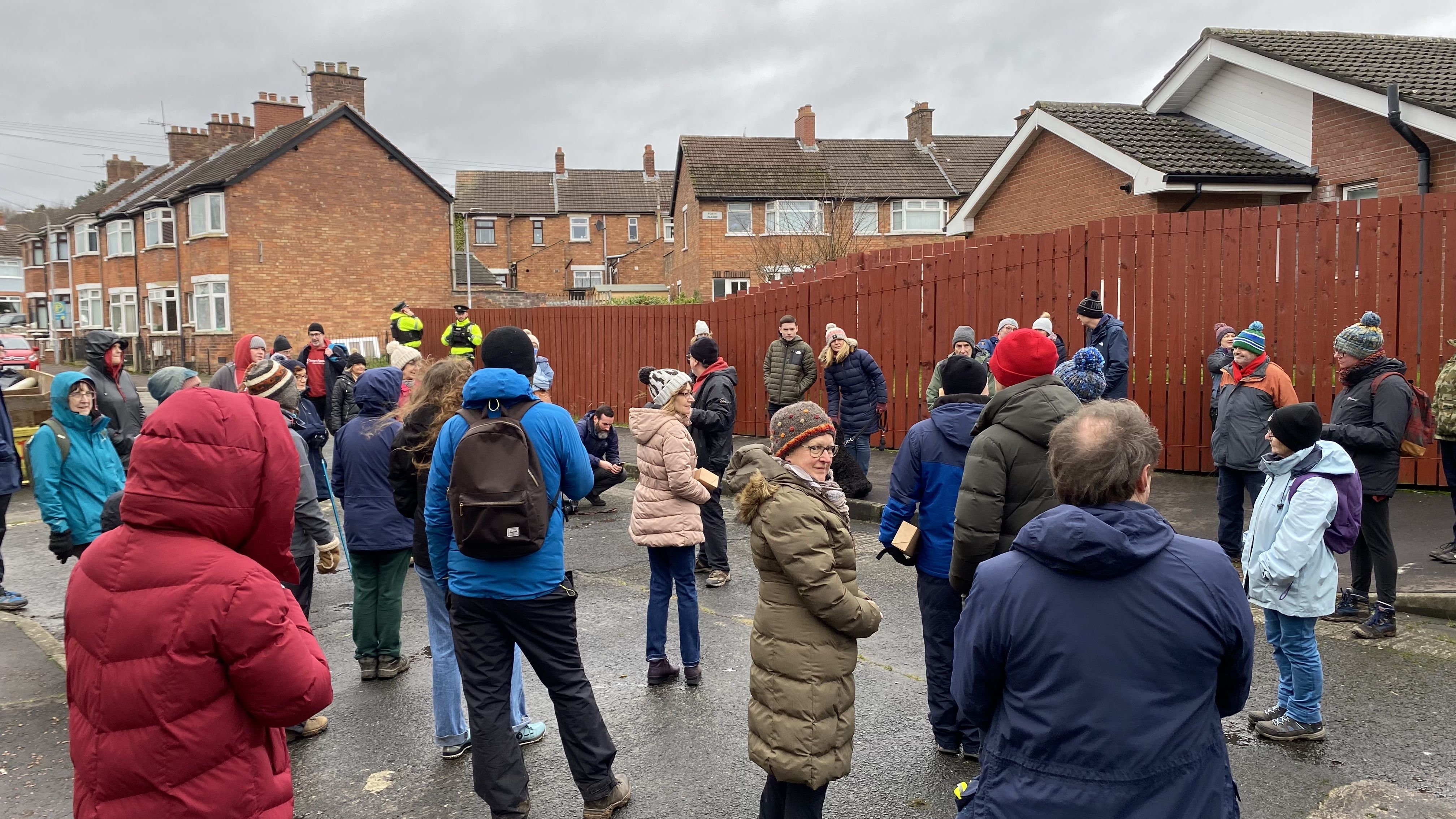 PEACE WALKERS: Participants in the 4 Corners Festival took part in a Wander Walk from Glencairn to Farset on Sunday, pausing at the peace line at Workman Avenue