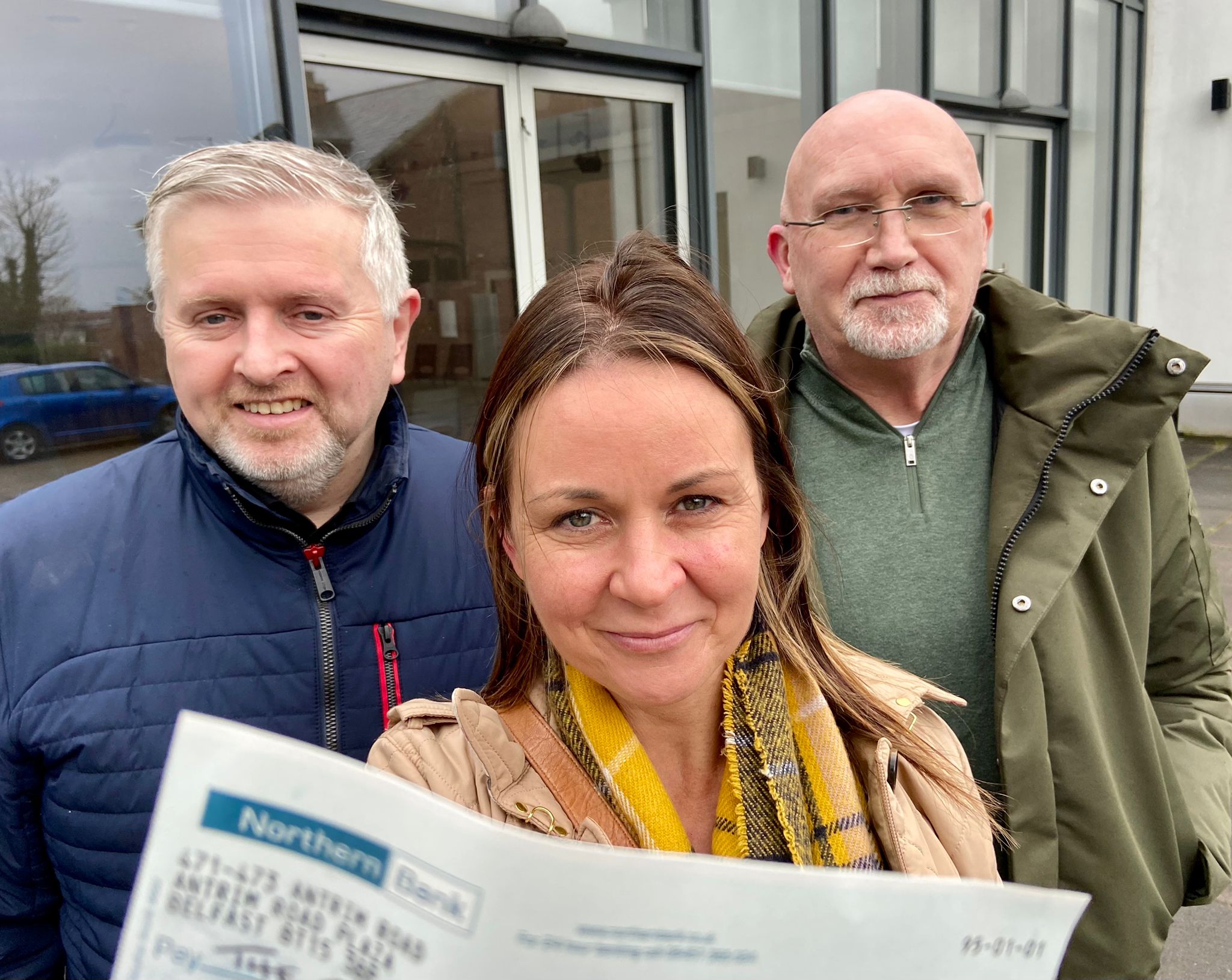 DONATION: Fr Gary Donegan and Bill Shaw present the cheque to Nichola Bradley of the Community Food Bank in Ardoyne