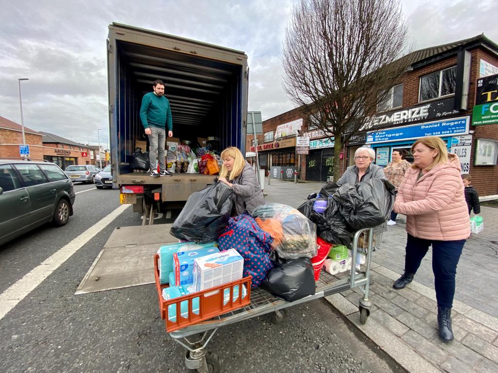 COMING TOGETHER: Filling up a container lorry of clothing and goods on the Andersonstown Road