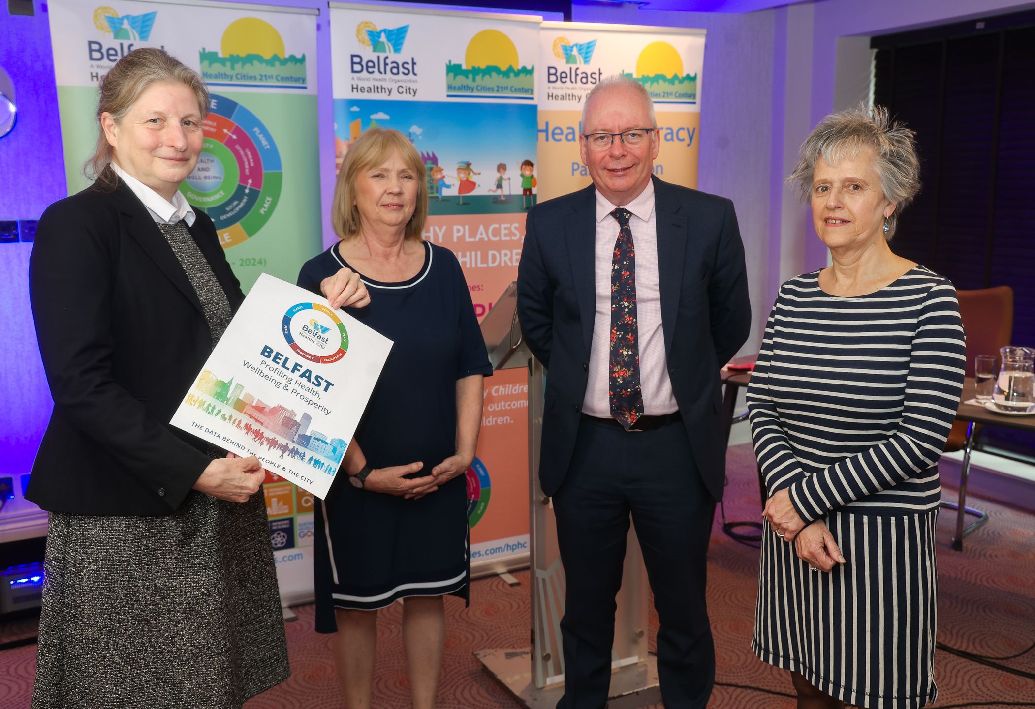 REPORT: Erica Ison, Healthy Cities Expert Advisor, Joan Devlin, Chief Executive Belfast Healthy Cities, Aidan Dawson, Chief Executive, Public Health Agency, & Dr Karen Casson, Belfast Healthy Cities Interim Chair at the launch of the report