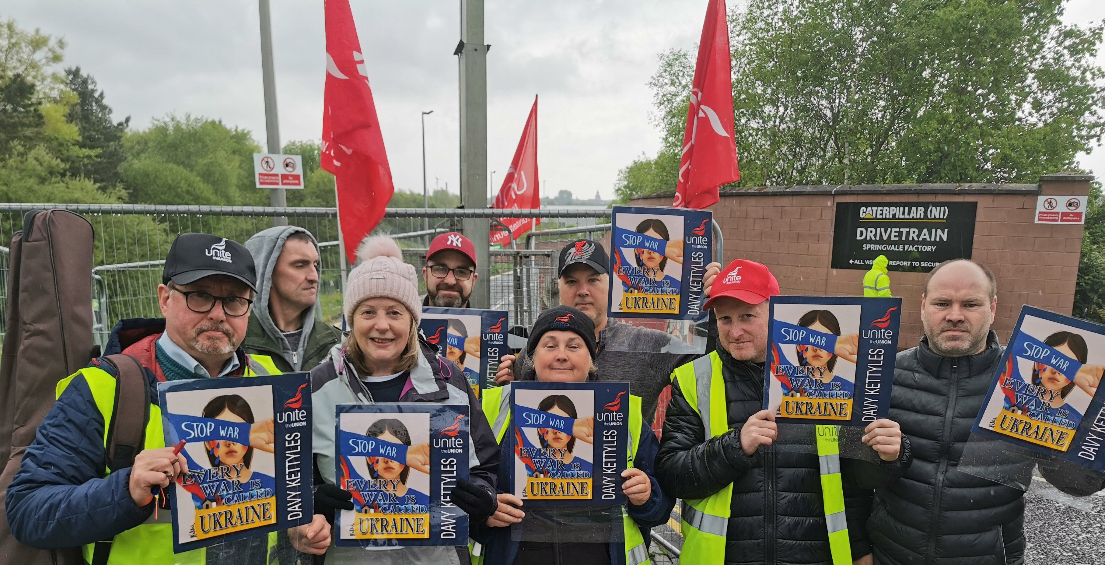 STIRRING: Striking Unite members at the Caterpillar site at Springvale West Belfast take time out to promote the a new anti-war song