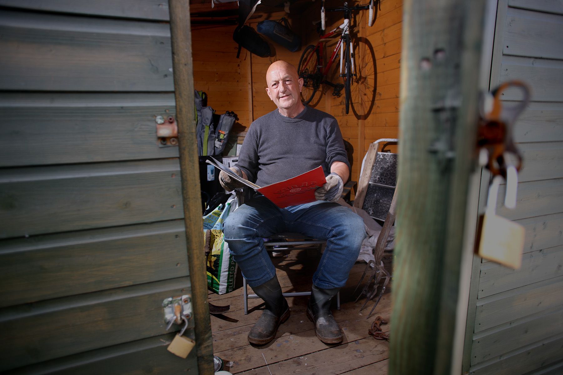 BEHIND THE DOOR: Paul Kennedy at home in his garden shed with with scrap book of poems