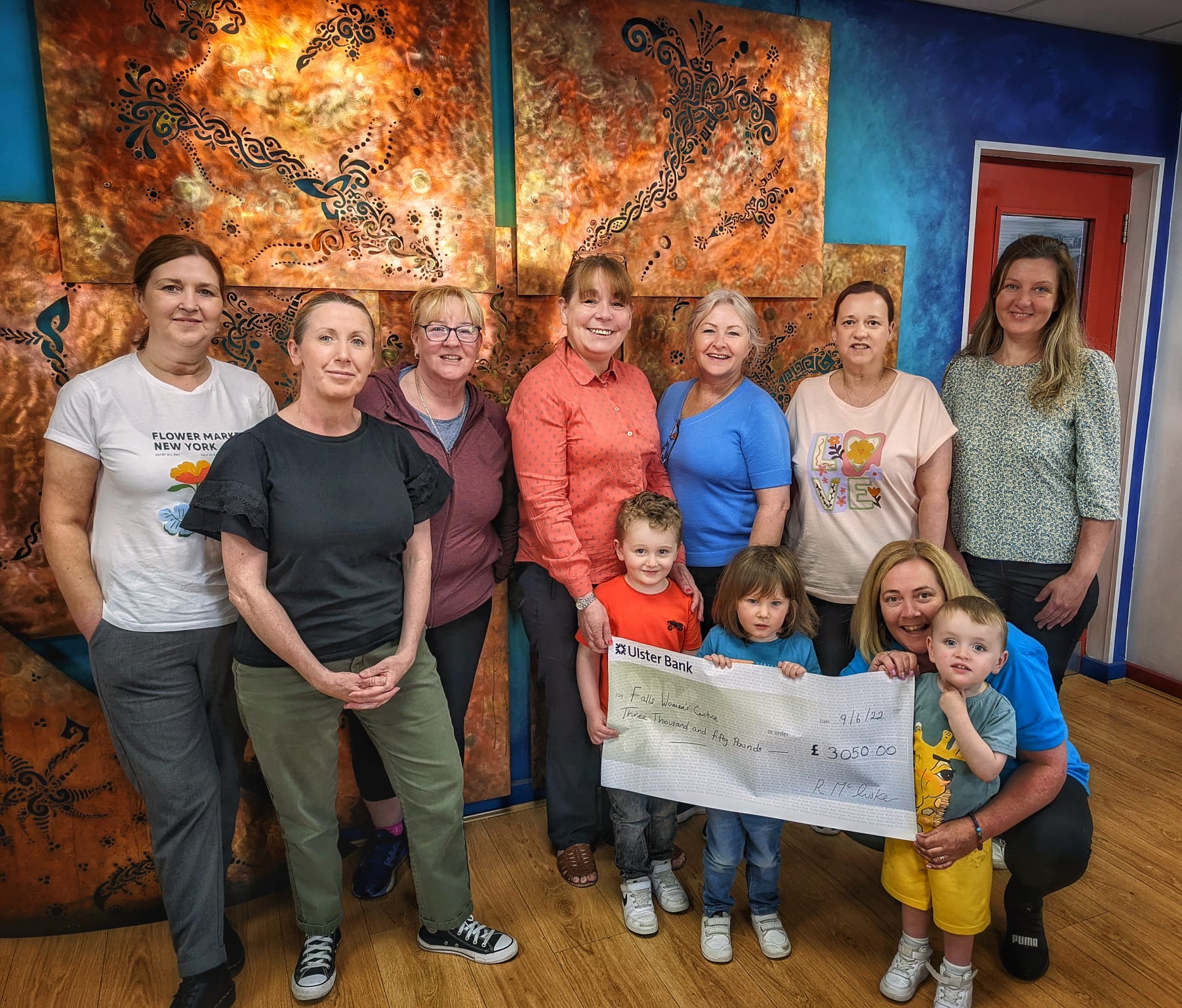 CHEQUE: Maura McCrory\'s daughter Rosie presented the cheque to the staff of Falls Women\'s Centre