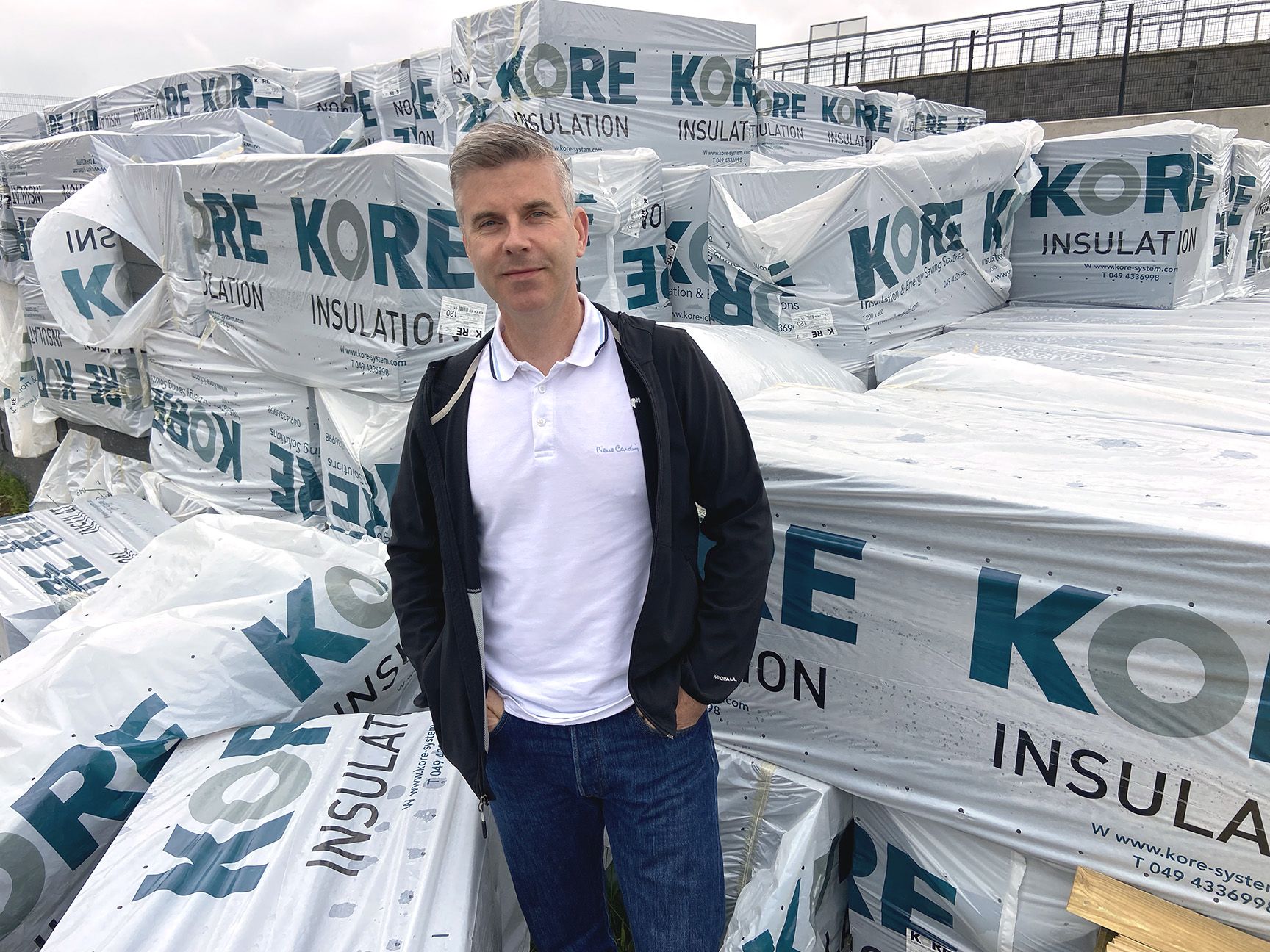 FUTURE PROOFING: Cllr Steven Corr with some of the cladding which will help future-proof homes in Ballymurphy