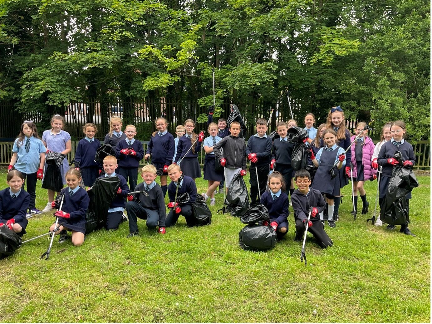 BIG CLEAN: Primary Six pupils at Good Shepherd in Poleglass have been cleaning up the streets close to their school