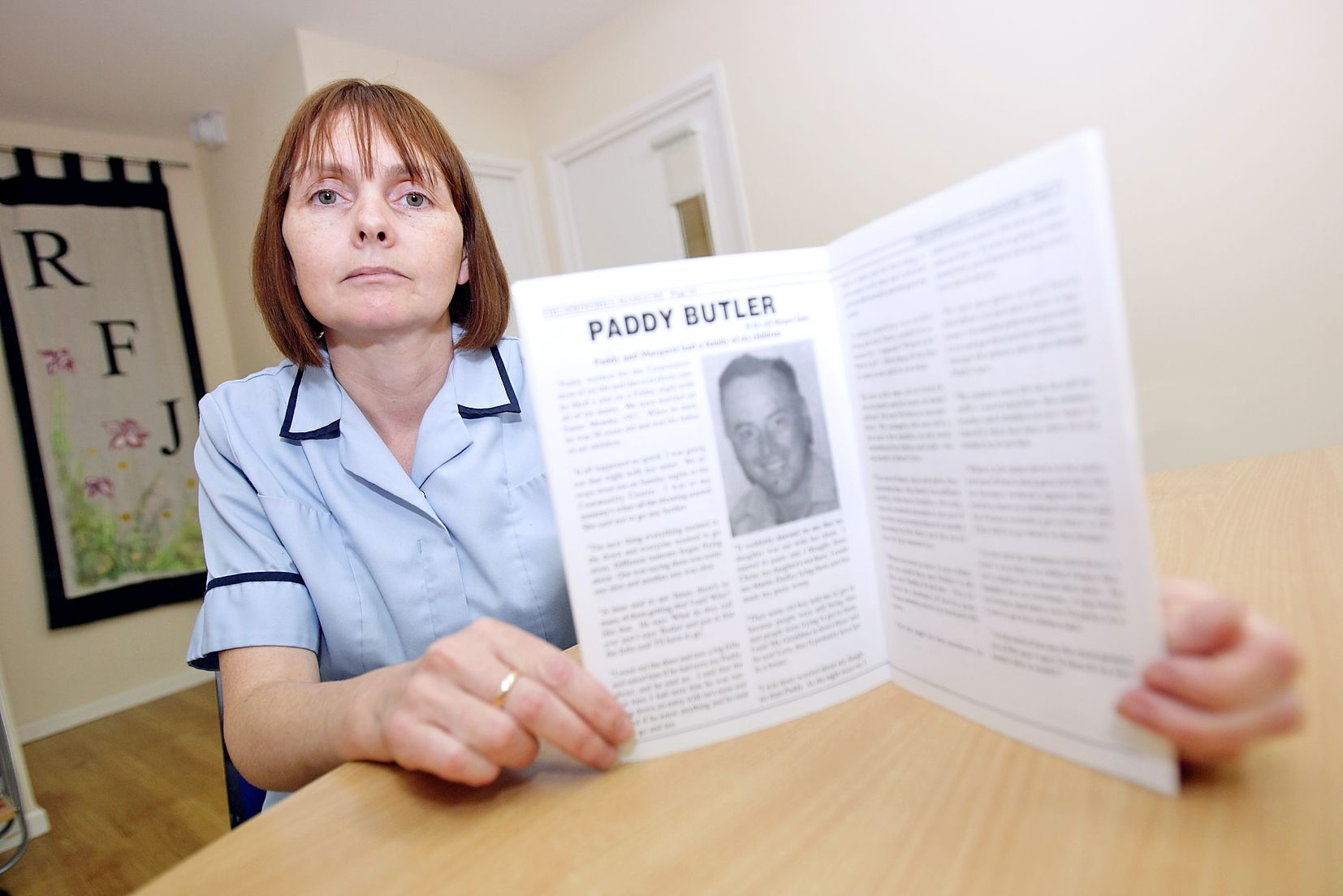 Jacqueline Butler with a booklet commemorating her father, Patrick Butler