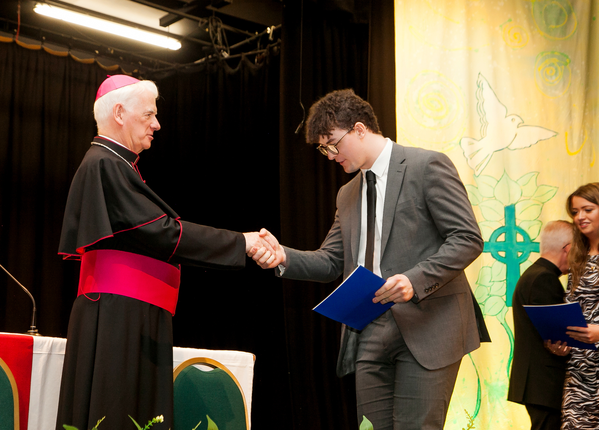 The Most Rev Noel Treanor, Bishop of Down and Connor and Chair of St Mary’s Governing Body, presents Conall Stott with his Certificate in Religious Education