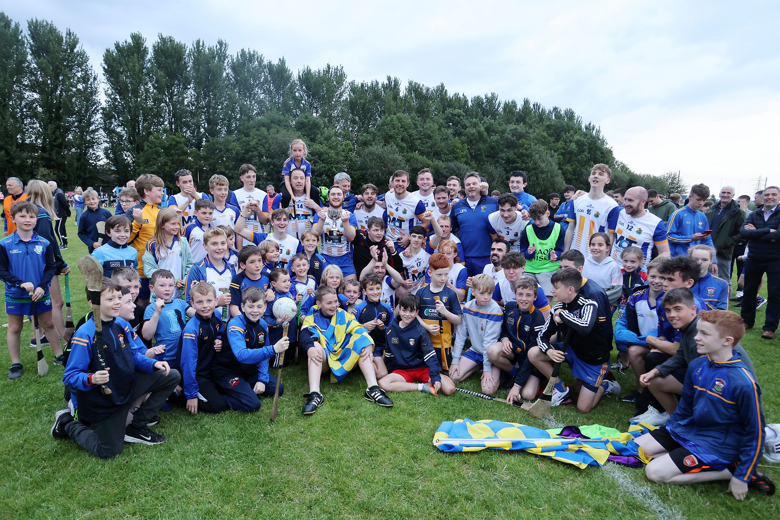 St Brigid\'s players, supporters and management celebrate with the cup after the game 