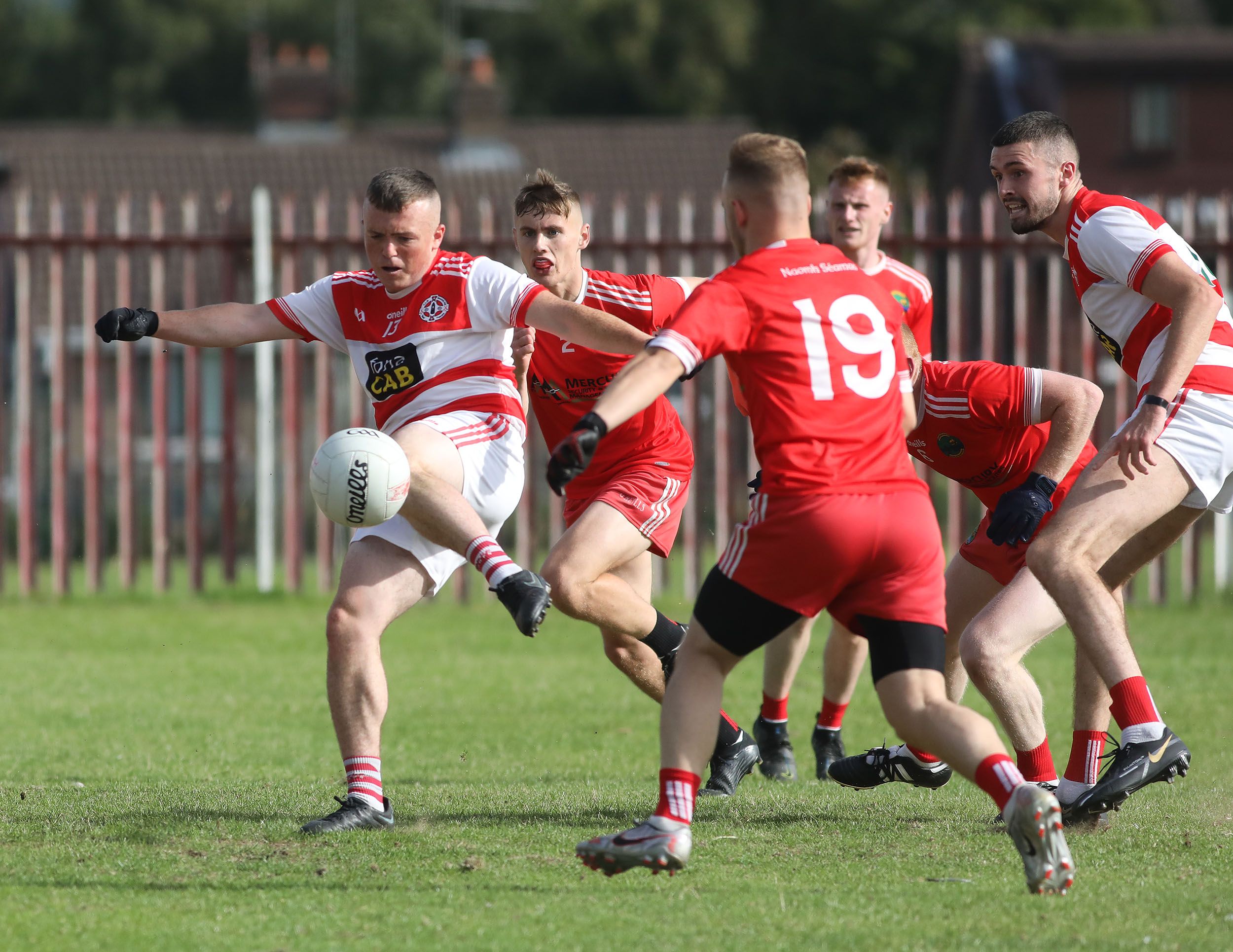 Conal Duffy swings his boot at a ball that goes up and over for a point during Saturday\'s game as St Paul\'s claimed the win they needed over Aldergrove 