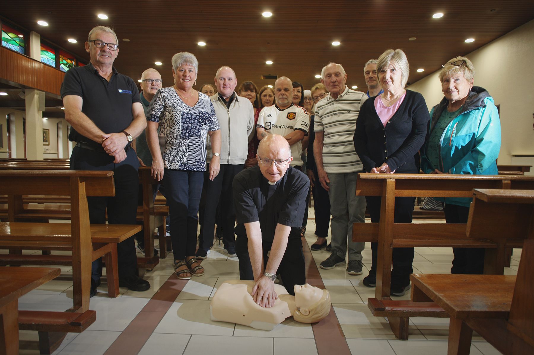 ON HAND: Fr Aidan Brankin joined St Oliver Plunkett parish staff and parishioners to be trained in the use of their newly purchased defibrillator 
