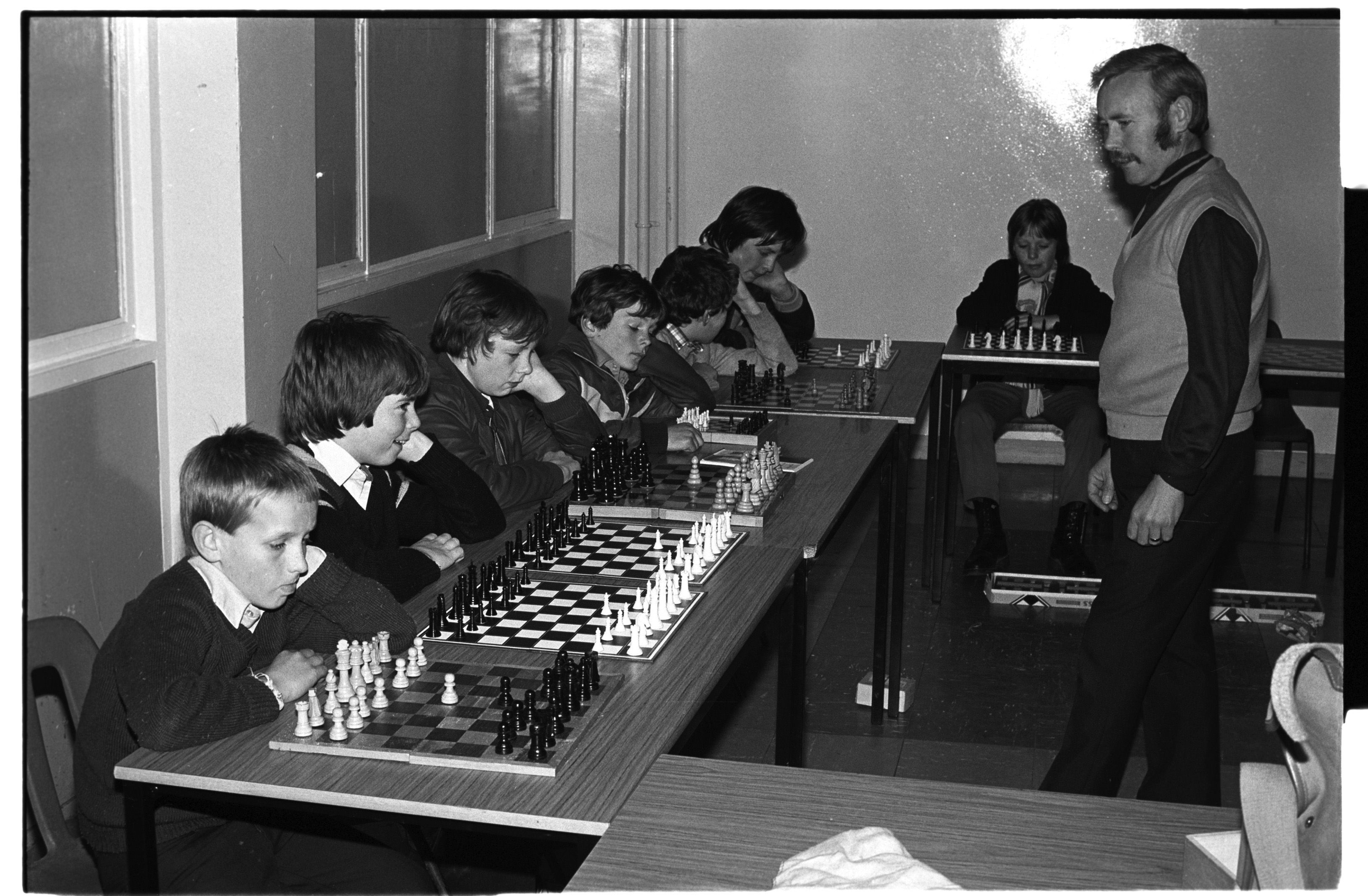 CHECKMATE: Eddie Neeson (standing) playing chess against kids from St Michael\'s Youth Club (L-R) Edward Neeson, Chris Lees, Stevie Smyth, Pat O\'Connor, Michael McGuinness, Ronan McCrory, Billy Floyd (Paddy Doyle not in photo)