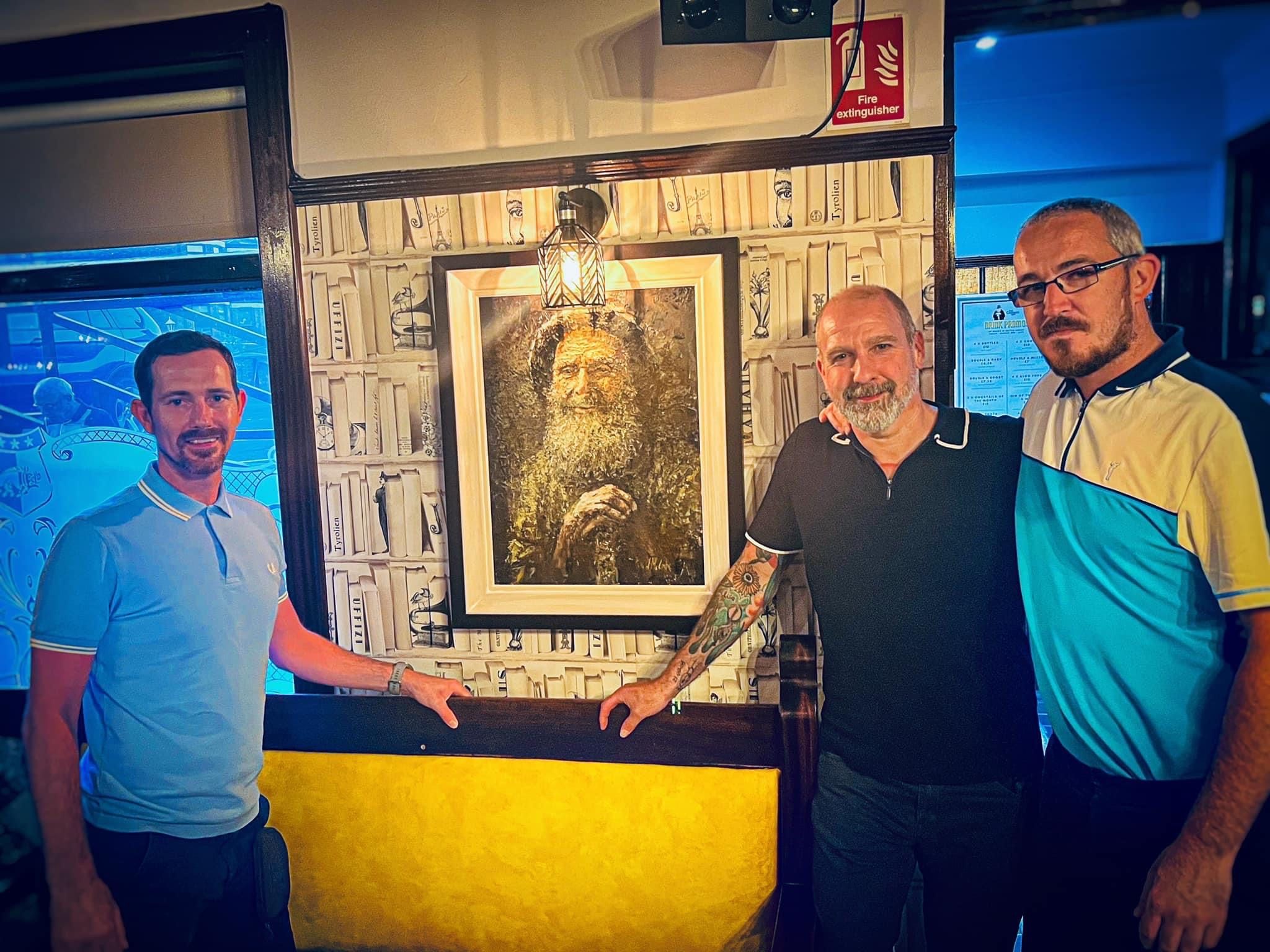 CROOKED MAN: Laurence and Damien Burns with their cousin Johnny McCabe (centre) unveiling his painting of The Crooked Man