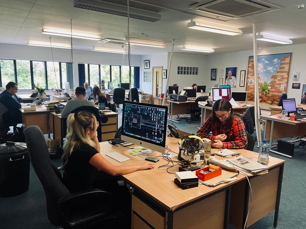 TRUSTED REPORTING: The newsroom today as Andersonstown News deadline approaches. Around 20 people, including nine journalists are on staff at the Belfast Media. (And, yes, for the sharp-eyed reader, that is David Ervine\'s portrait!)