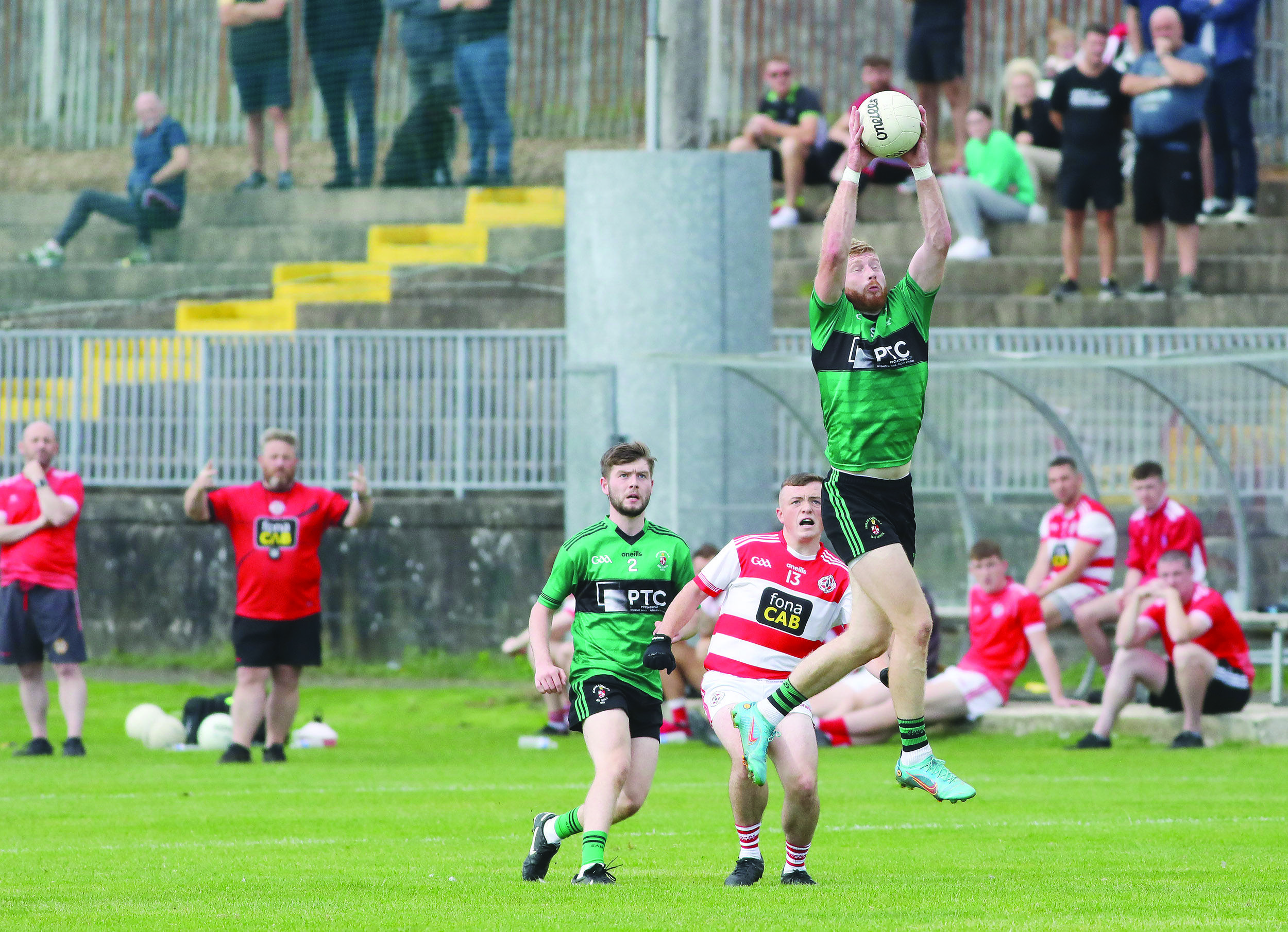 Niall McKenna rises high to fetch the ball during Sarsfield’s impressive quarter-final win over St Paul’s