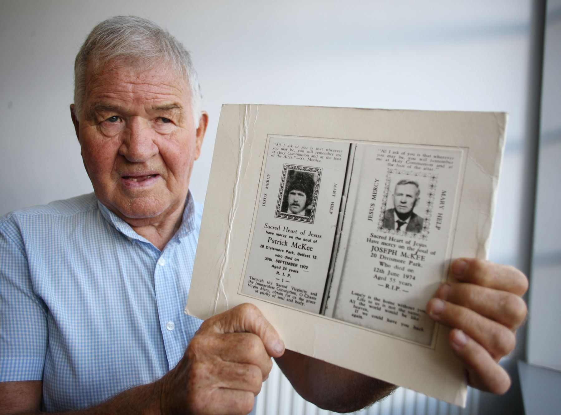 ANSWERS: Seamus McKee holds the memory card of his brother Patrick who was killed on 30 September 1972 and his father Joseph who died 18 months later