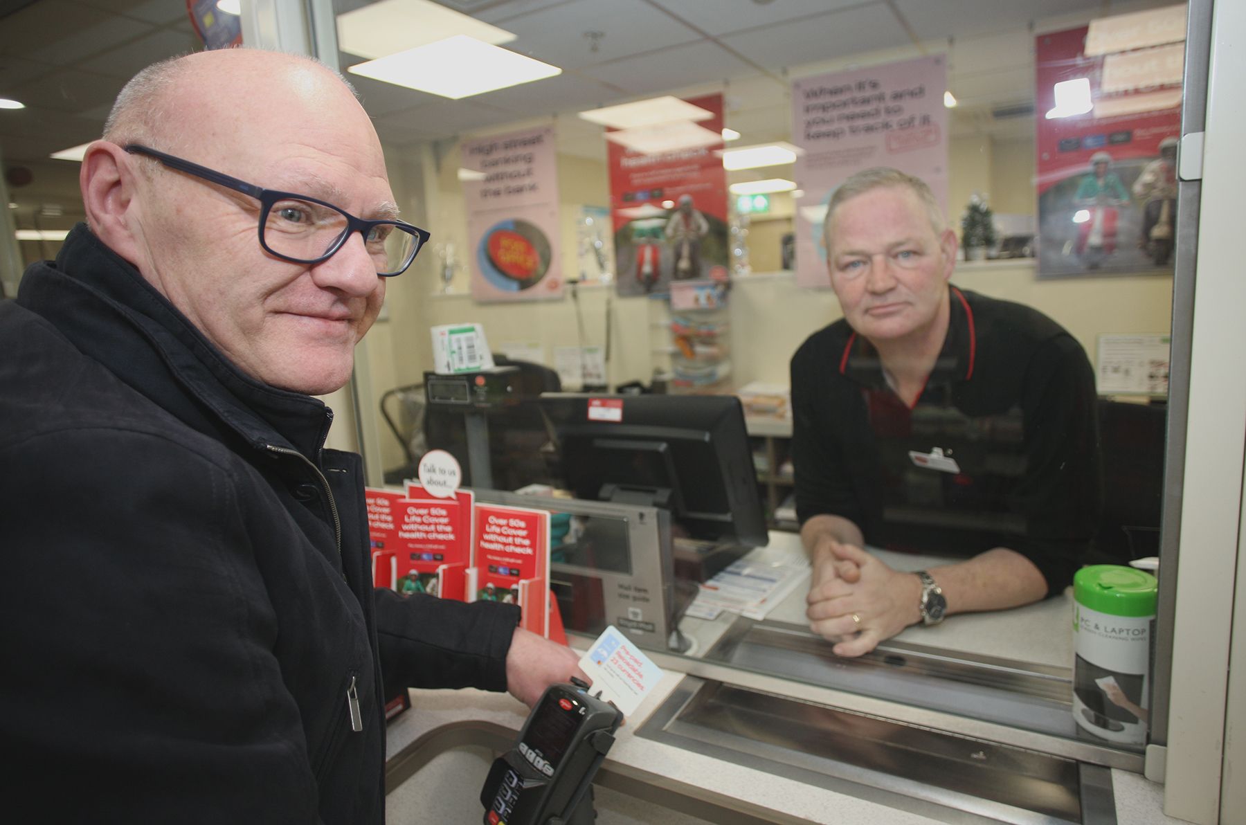 DIFFICULTIES: Paul Maskey MP met with Sub-Postmaster Jim McCafferty in the Kennedy Centre 