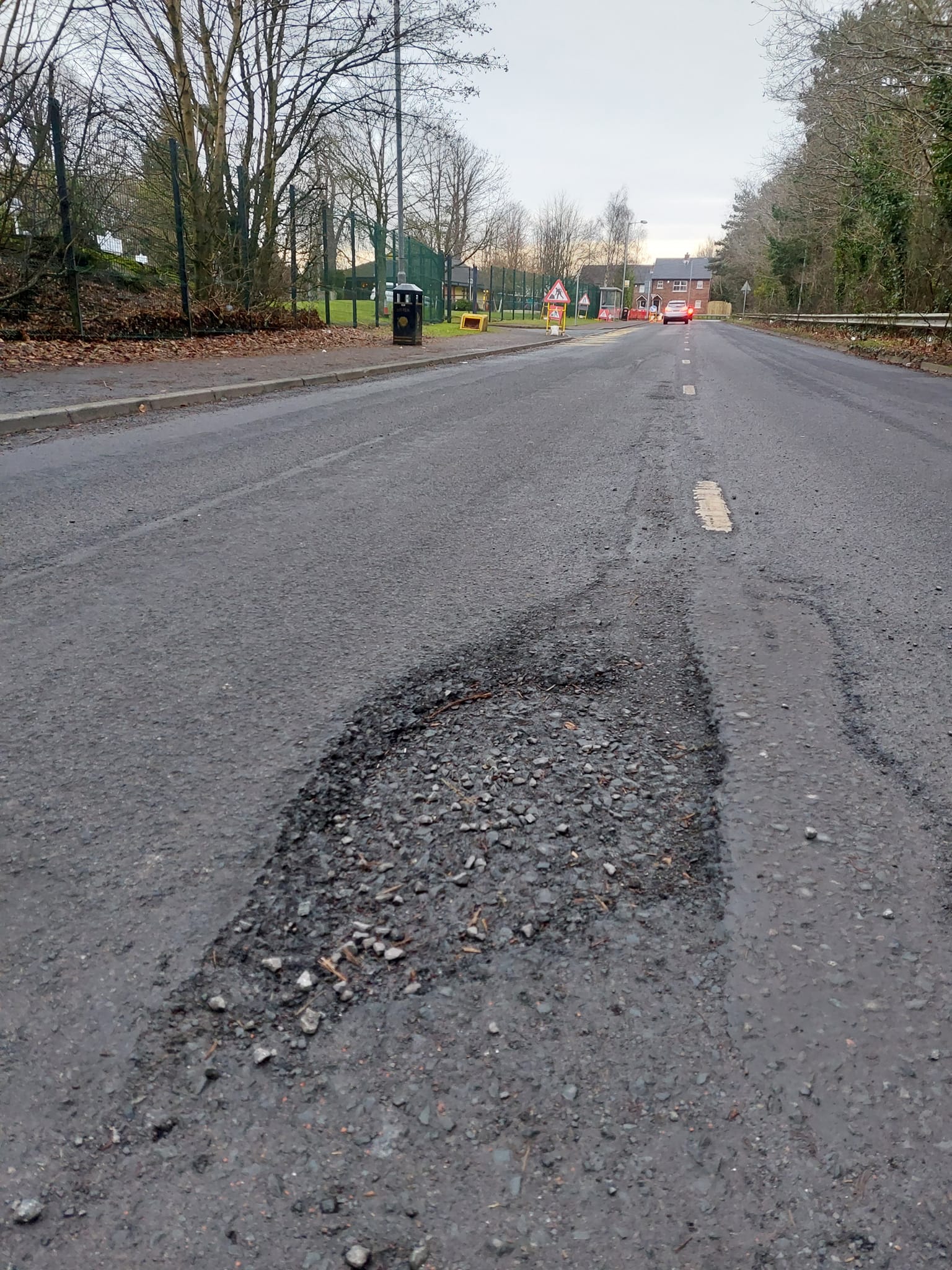 DAMAGE: PBP Councillor Michael Collins has urged DfI to carry out pothole repairs on Cherry Road as soon as possible