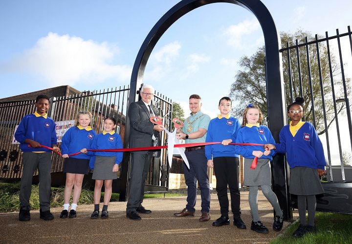 FUN TIME: Department for Communities Permanent Secretary Colum Boyle, Belfast Lord Mayor Councillor Ryan Murphy and pupils from Malvern Street Primary School pictured at the official opening of a new park on the Lower Shankill