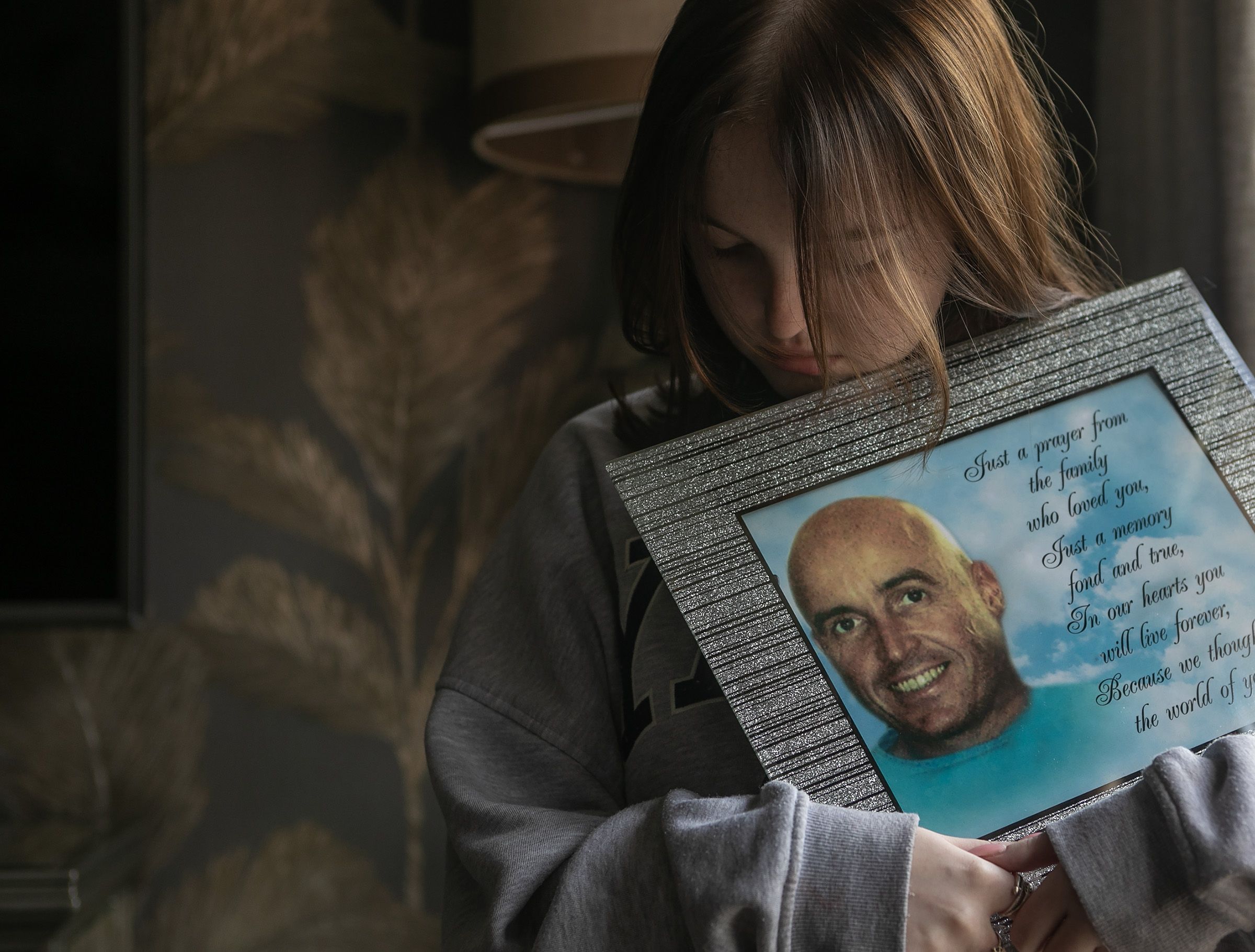 REMEMBERED: Jessica Kearney (18) with a photo of her dad, Kevin ahead of his tenth anniversary